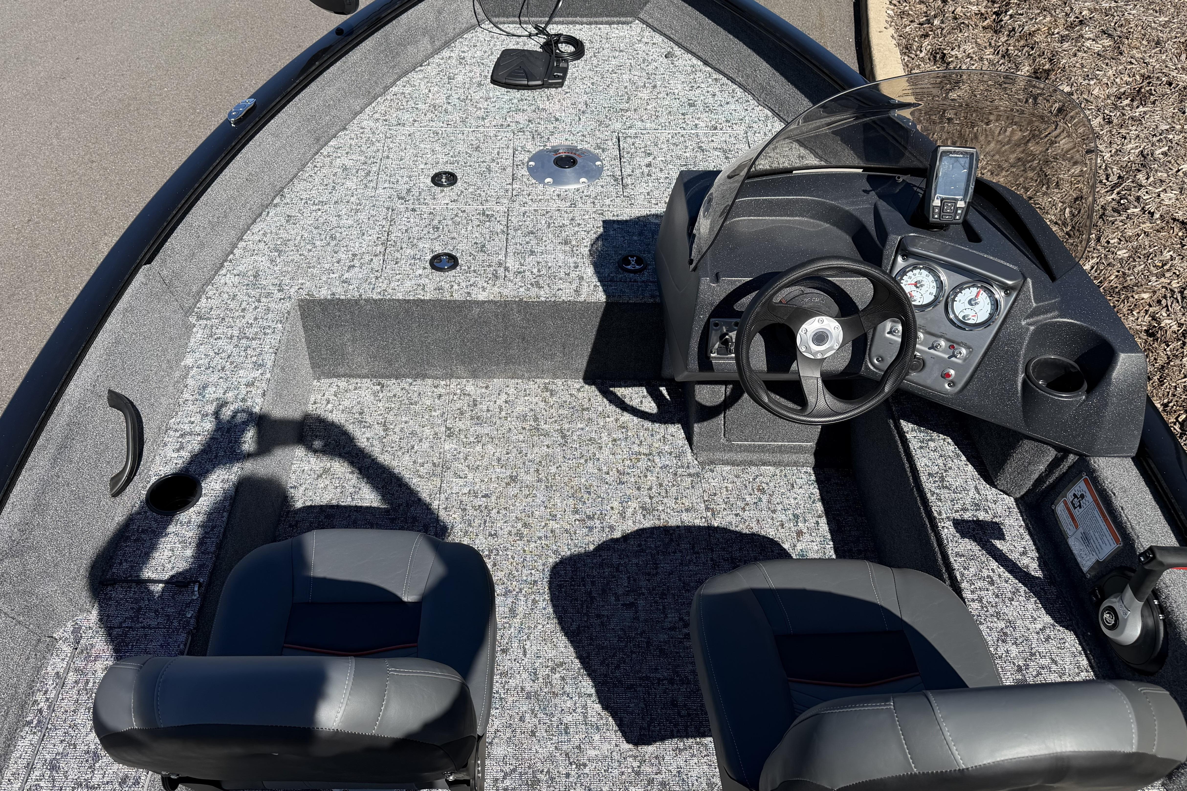 2026 Tracker Pro Guide V-16 SC boat interior with steering console and seating.