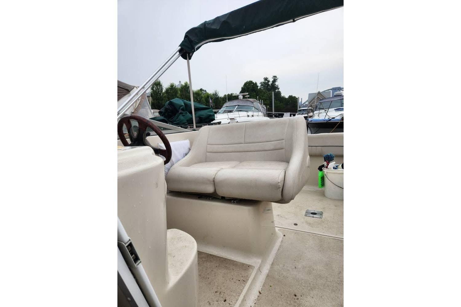 2001 Crownline 242 CR boat interior with beige seating and steering wheel.