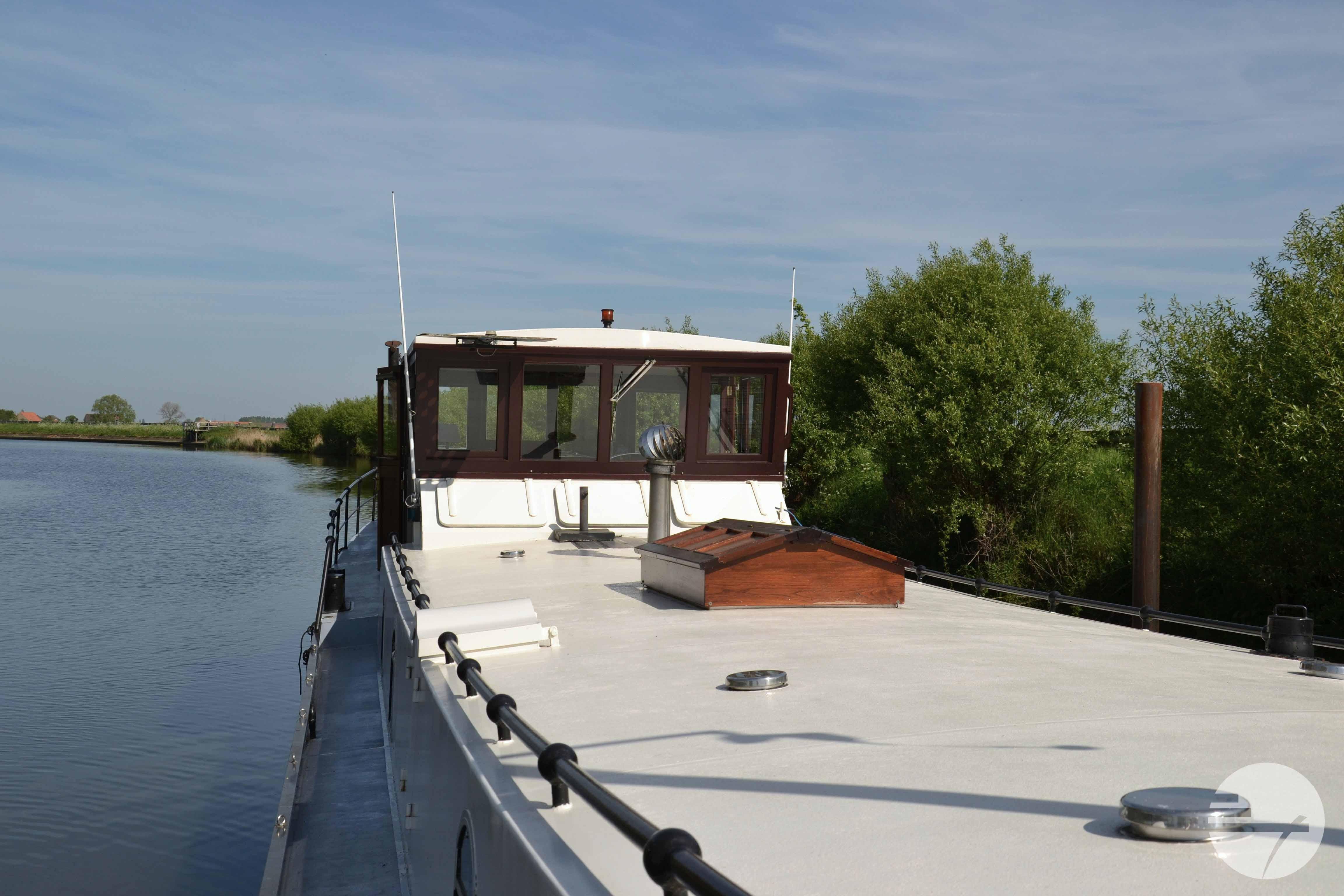 Custom 2010 Dutch Barge Replica on a serene river, surrounded by lush greenery.