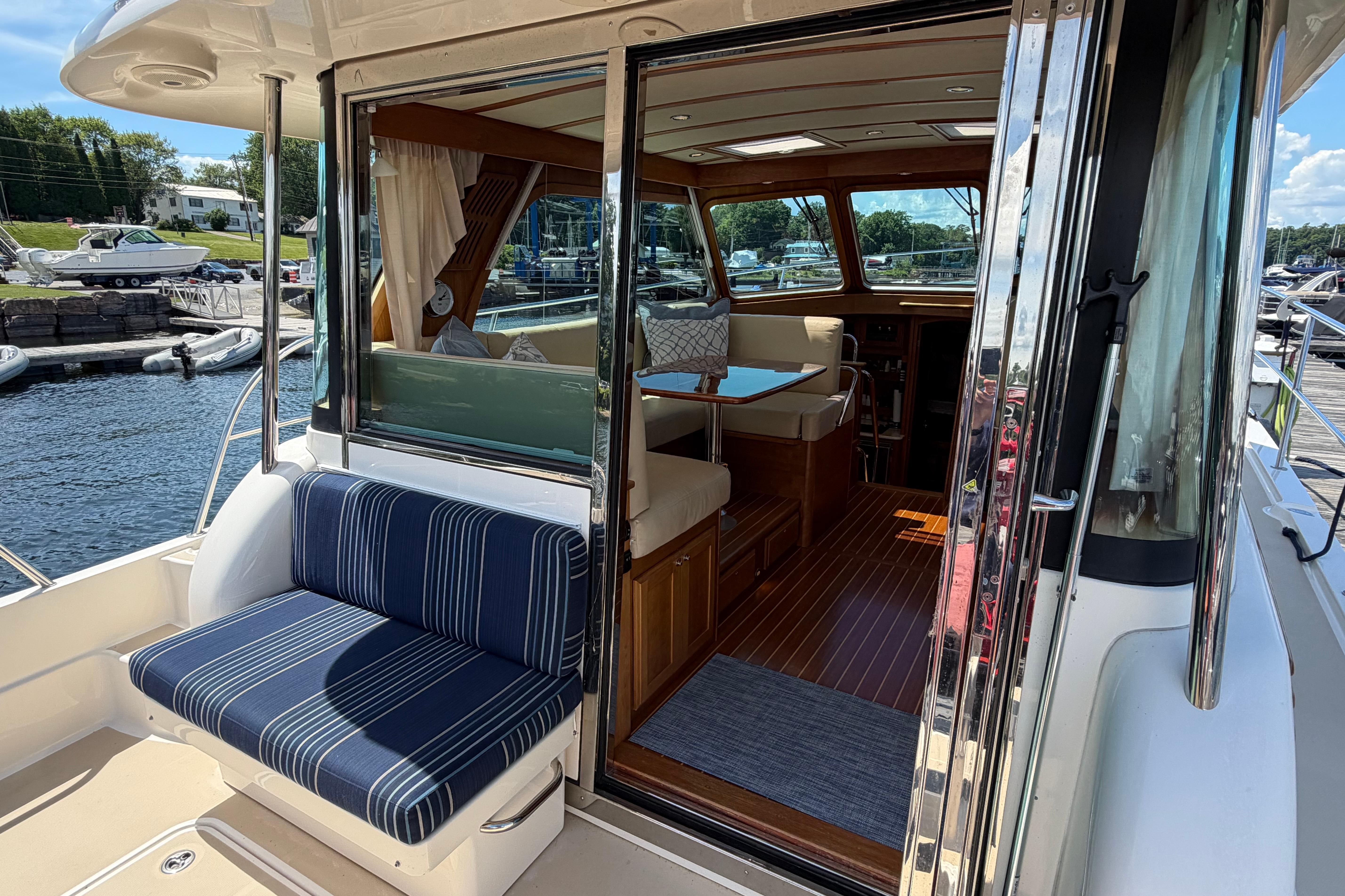 2015 Sabre 38 Salon Express yacht interior with striped seating and wooden accents.