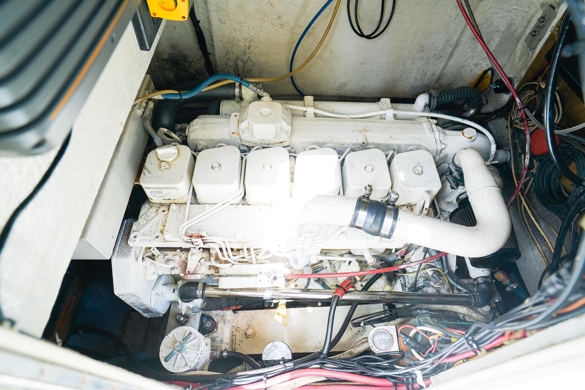 Engine compartment of a 1977 Scarborough 27 CC boat, showcasing detailed mechanical components.