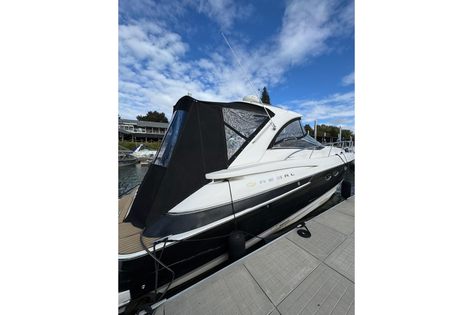 2006 Regal Commodore 4460 yacht docked under a blue sky.