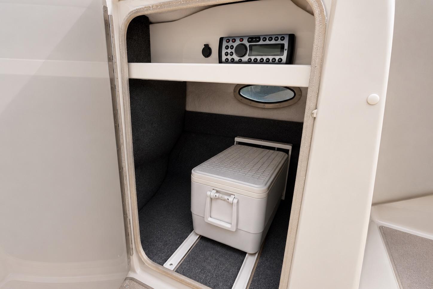 2004 Sea Ray 240 Sundeck interior storage with cooler and stereo system.