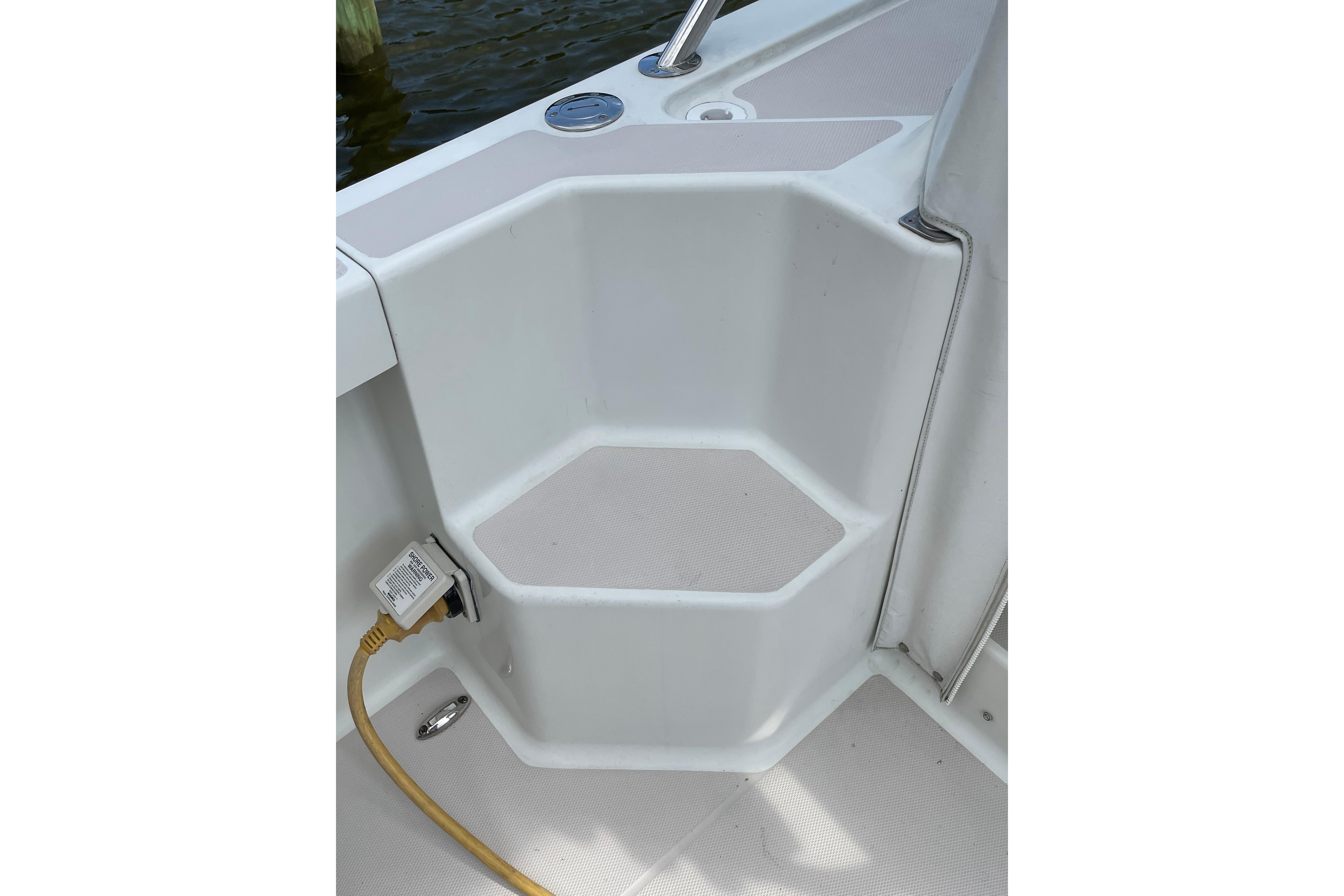2007 Back Cove 29 boat step with power outlet and non-slip surface.