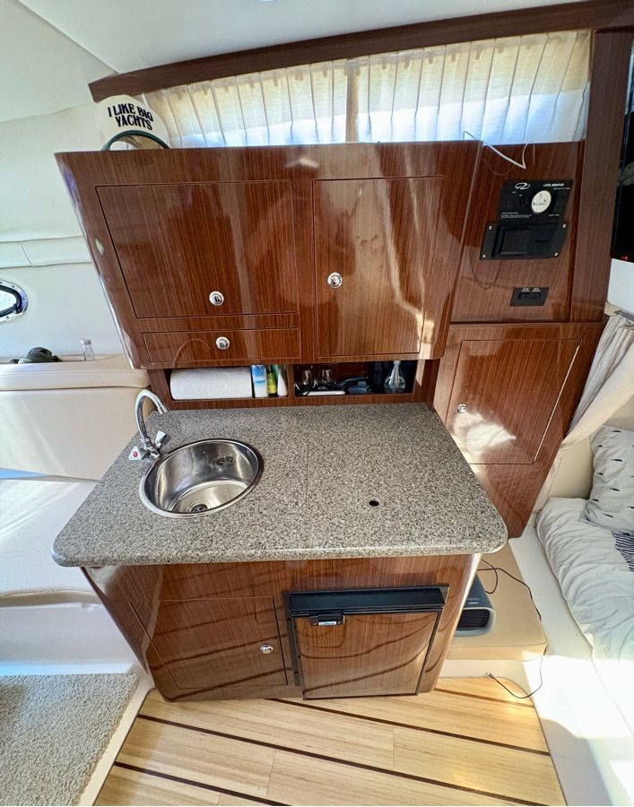 Interior of the 2014 Regal 30 Express with sink and wooden cabinets.