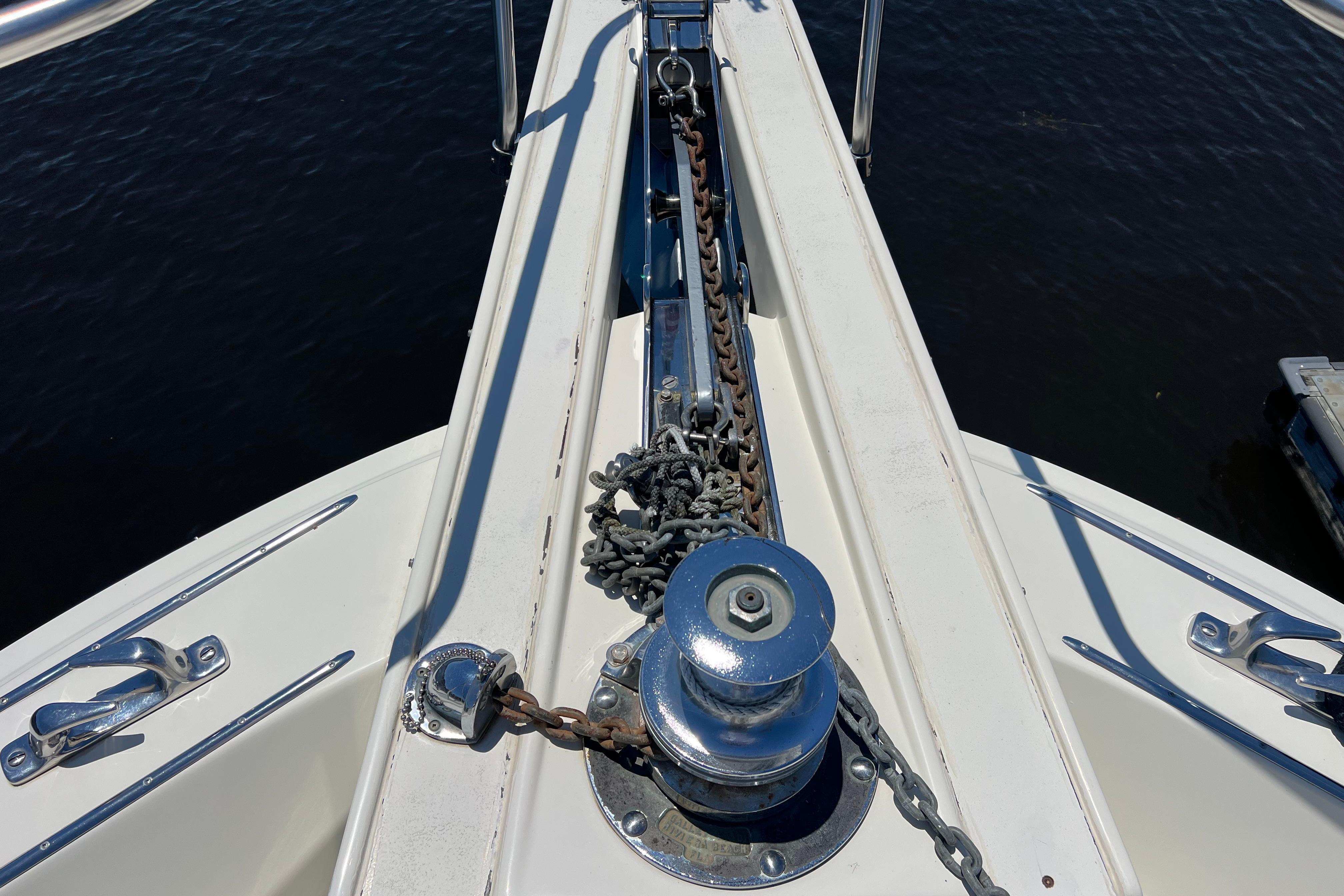 Bow of 1987 Hatteras 70 Cockpit Motor Yacht with anchor chain and winch.