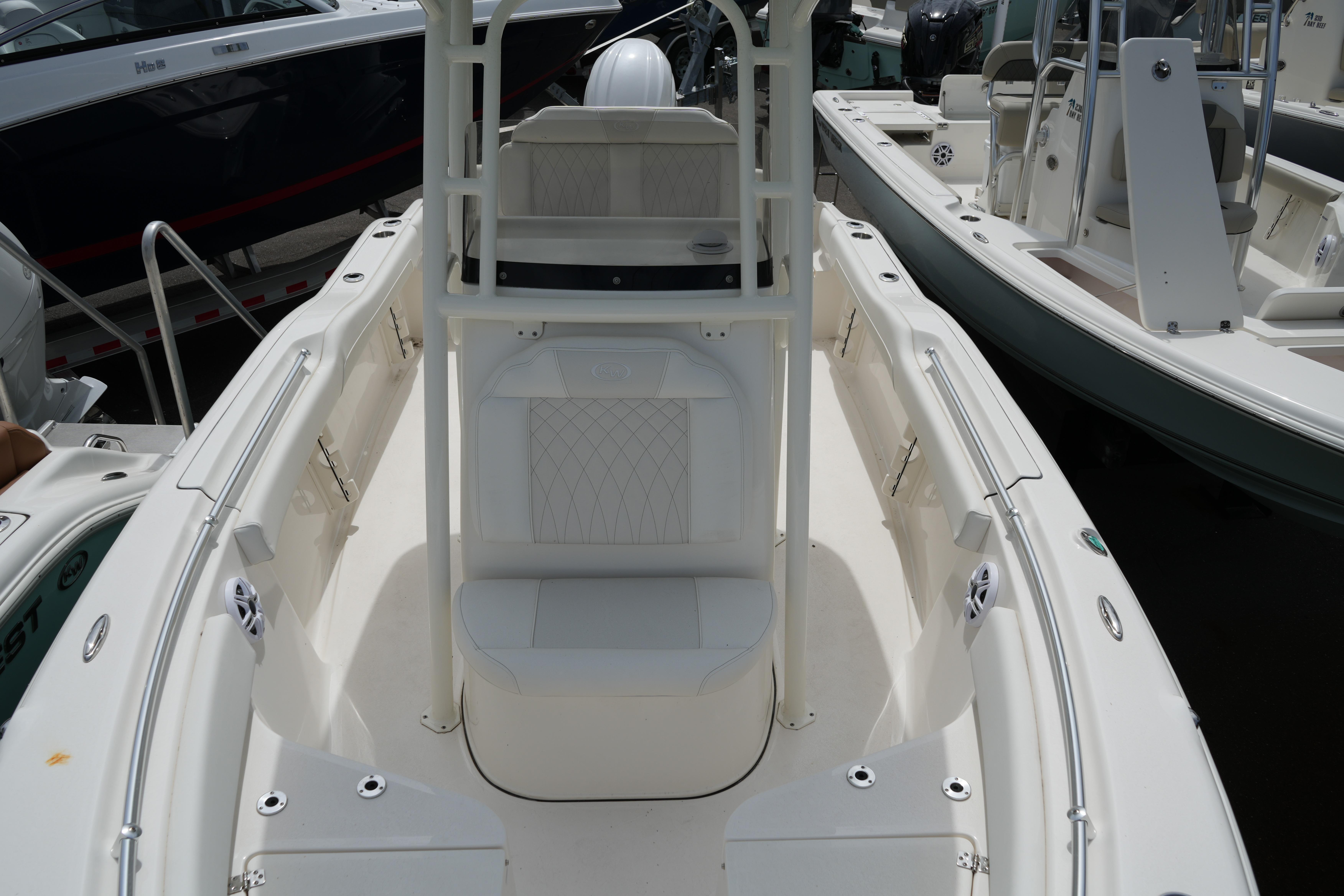 2026 Key West 219 FS boat interior with seating and console, docked among other boats.