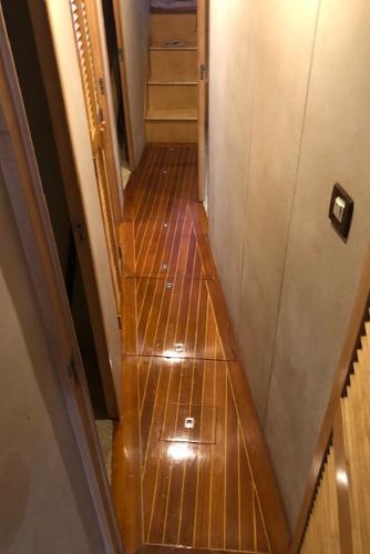 1997 Bertram Convertible yacht interior hallway with polished wooden flooring.