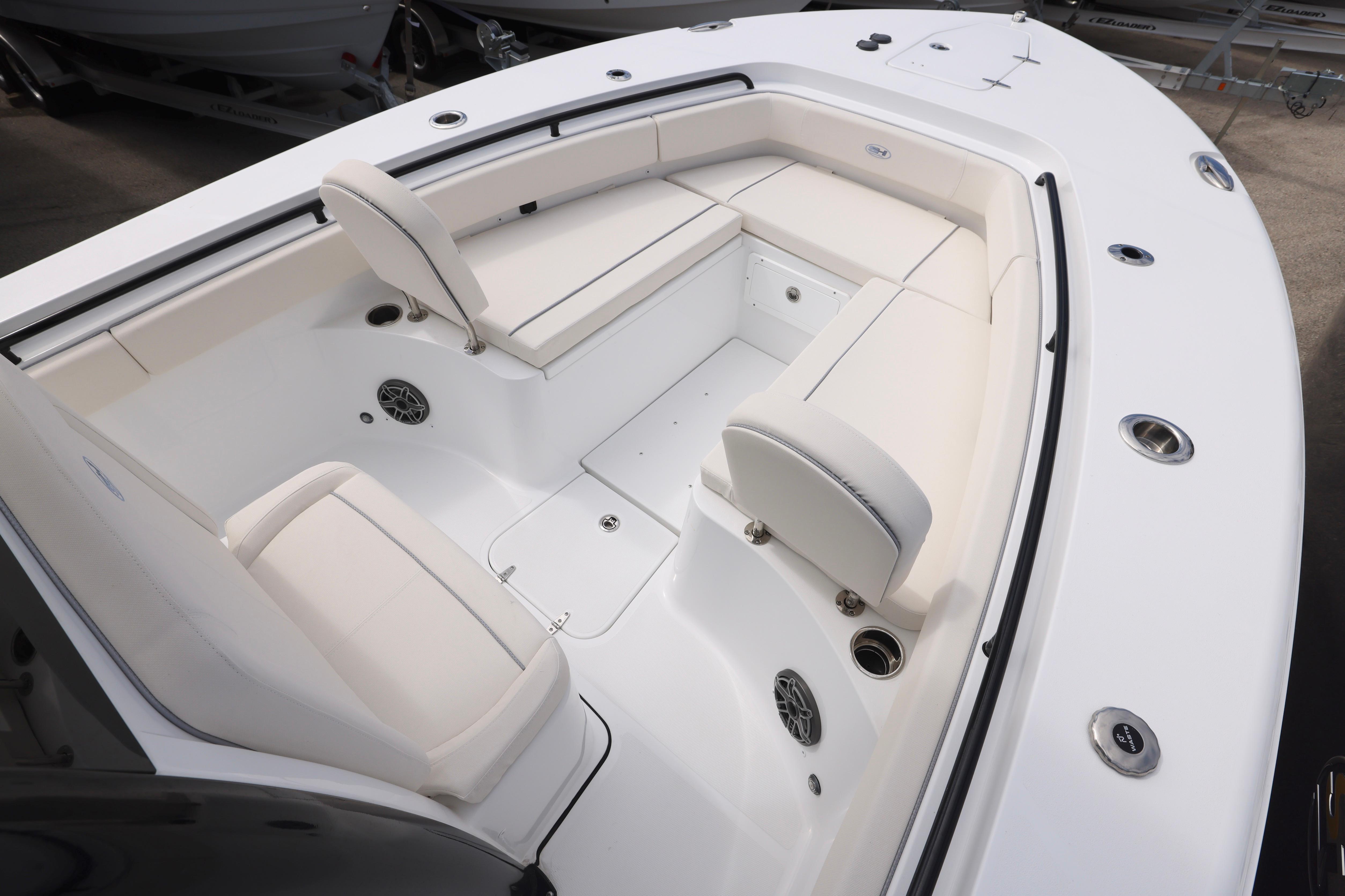 2026 Sea Hunt Gamefish 25 boat interior with white cushioned seating and stainless steel fixtures.
