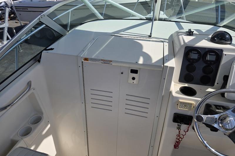 2004 Robalo R235 Walkaround boat cockpit with steering wheel and control panel.