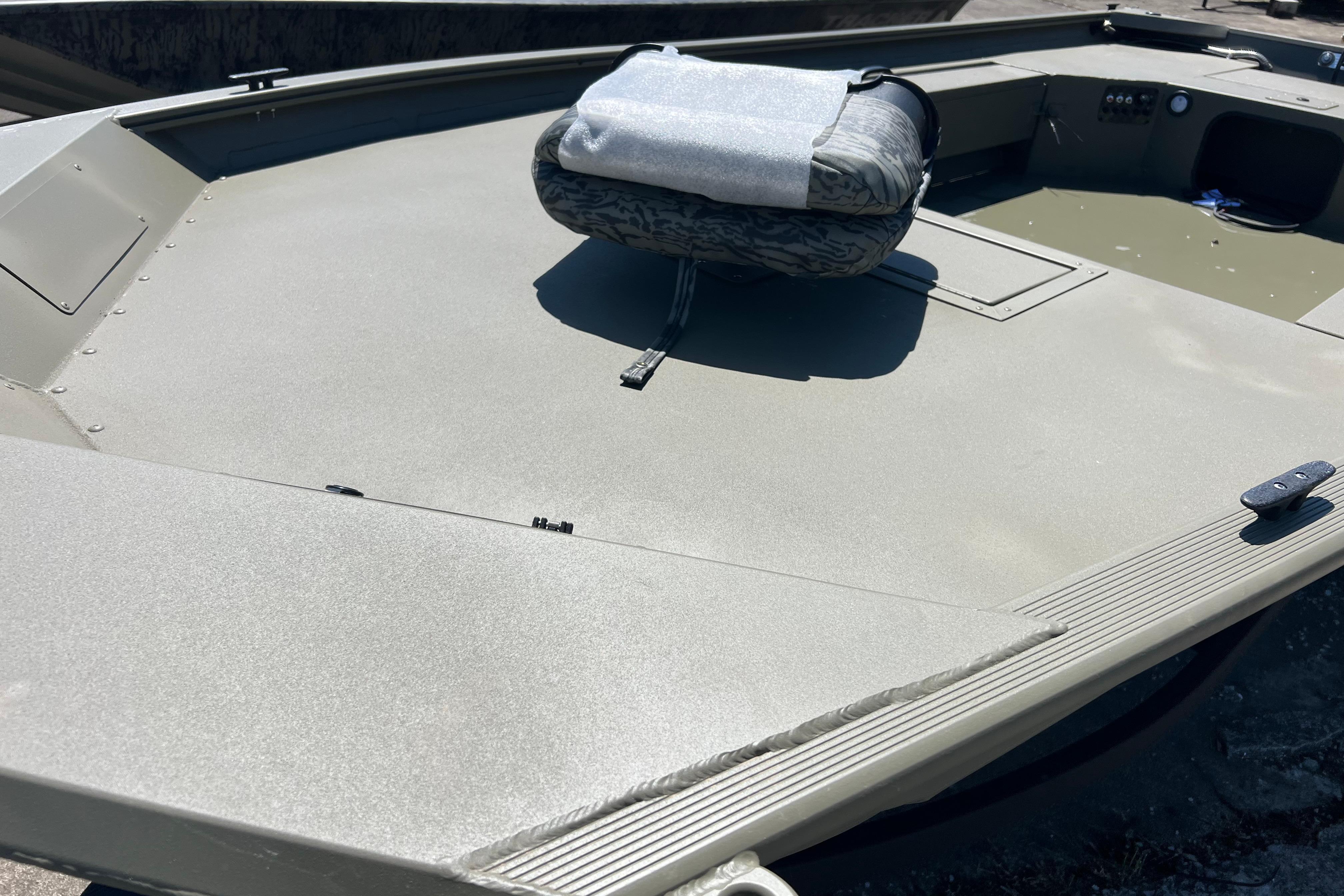 2026 Tracker Grizzly 1654 T Sportsman boat deck with seating and storage compartments.
