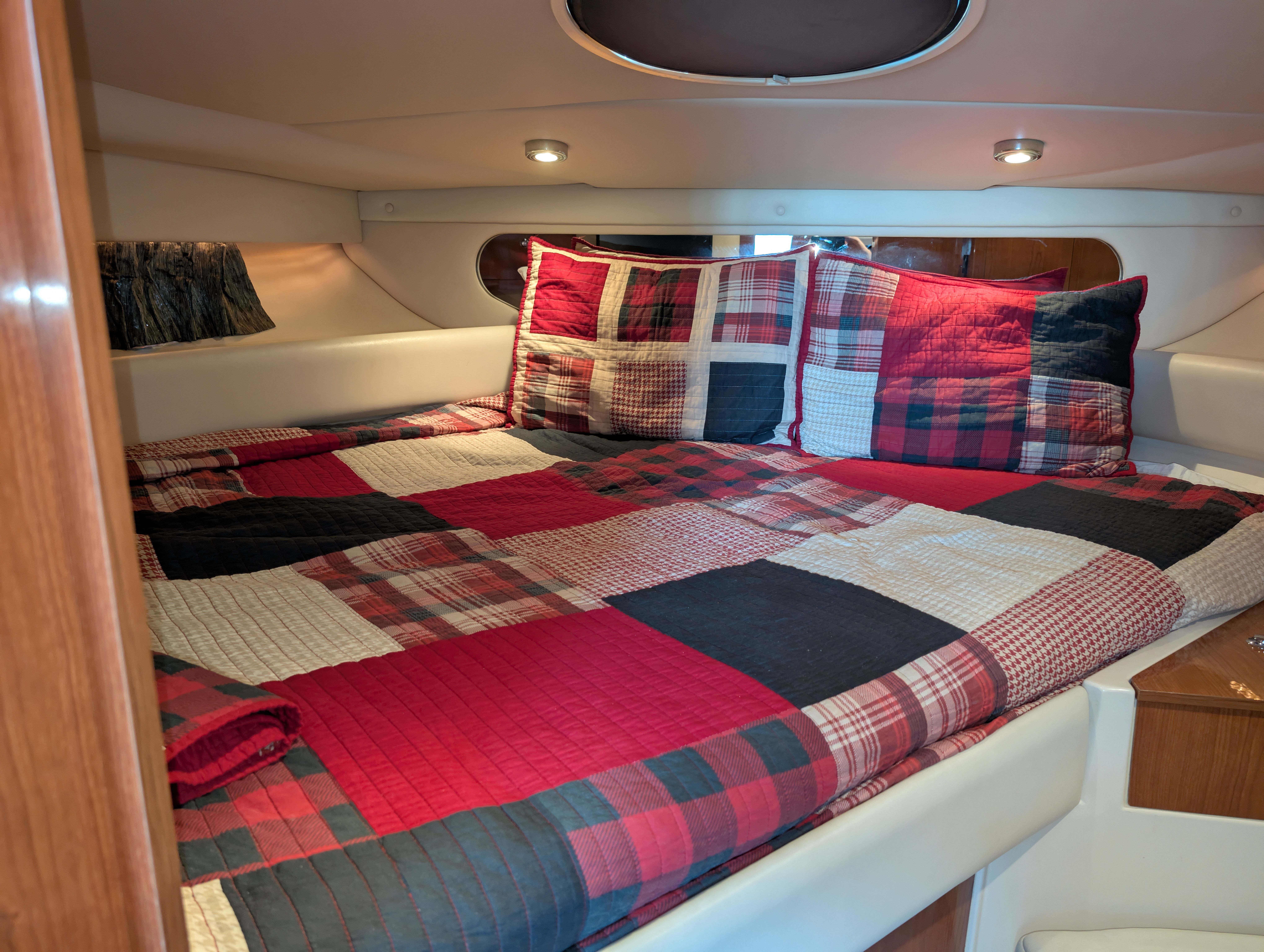Interior of a Regal Commodore 3560 yacht with plaid bedding.