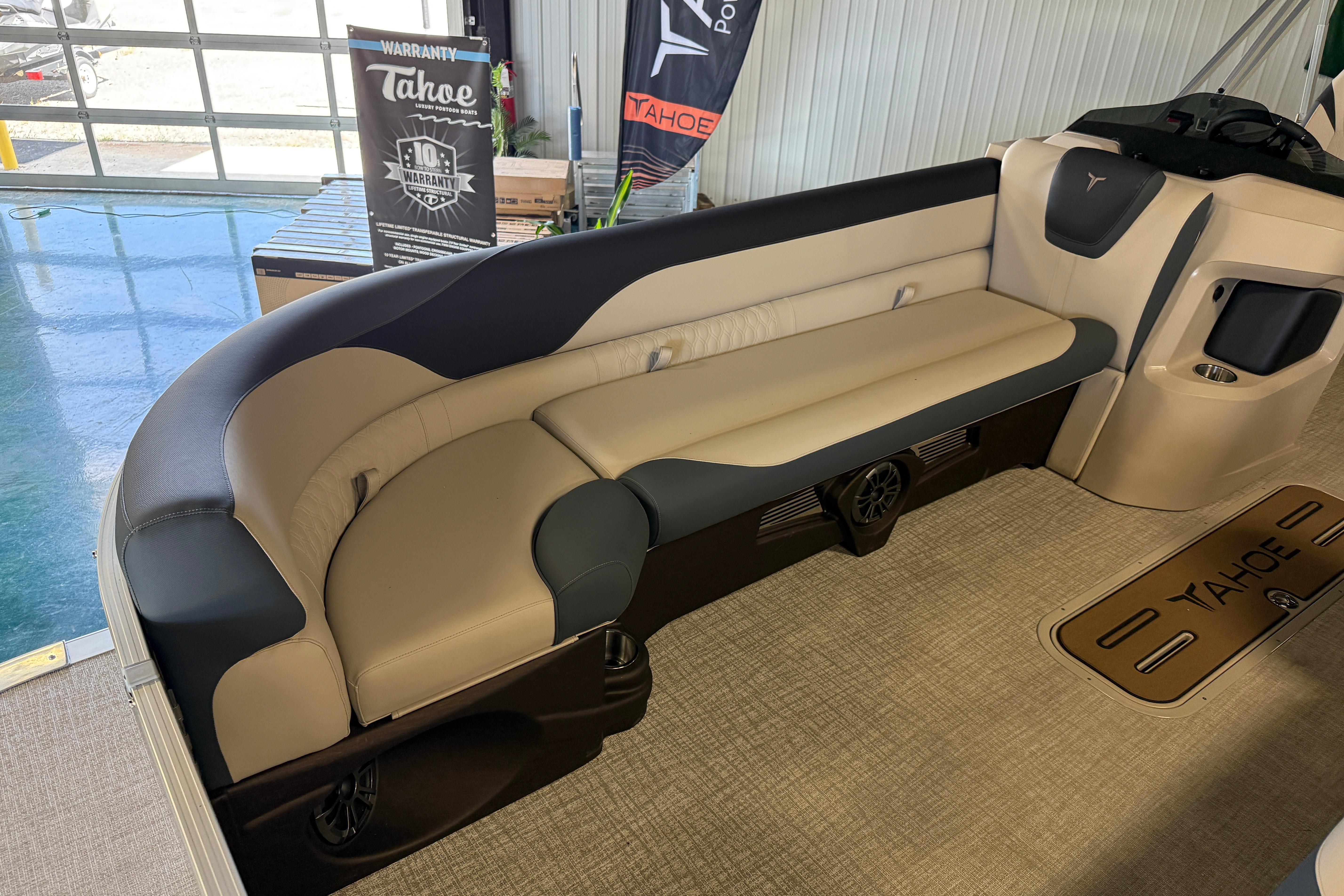2026 Tahoe Pontoon LTZ Entertainer interior with beige and black seating.