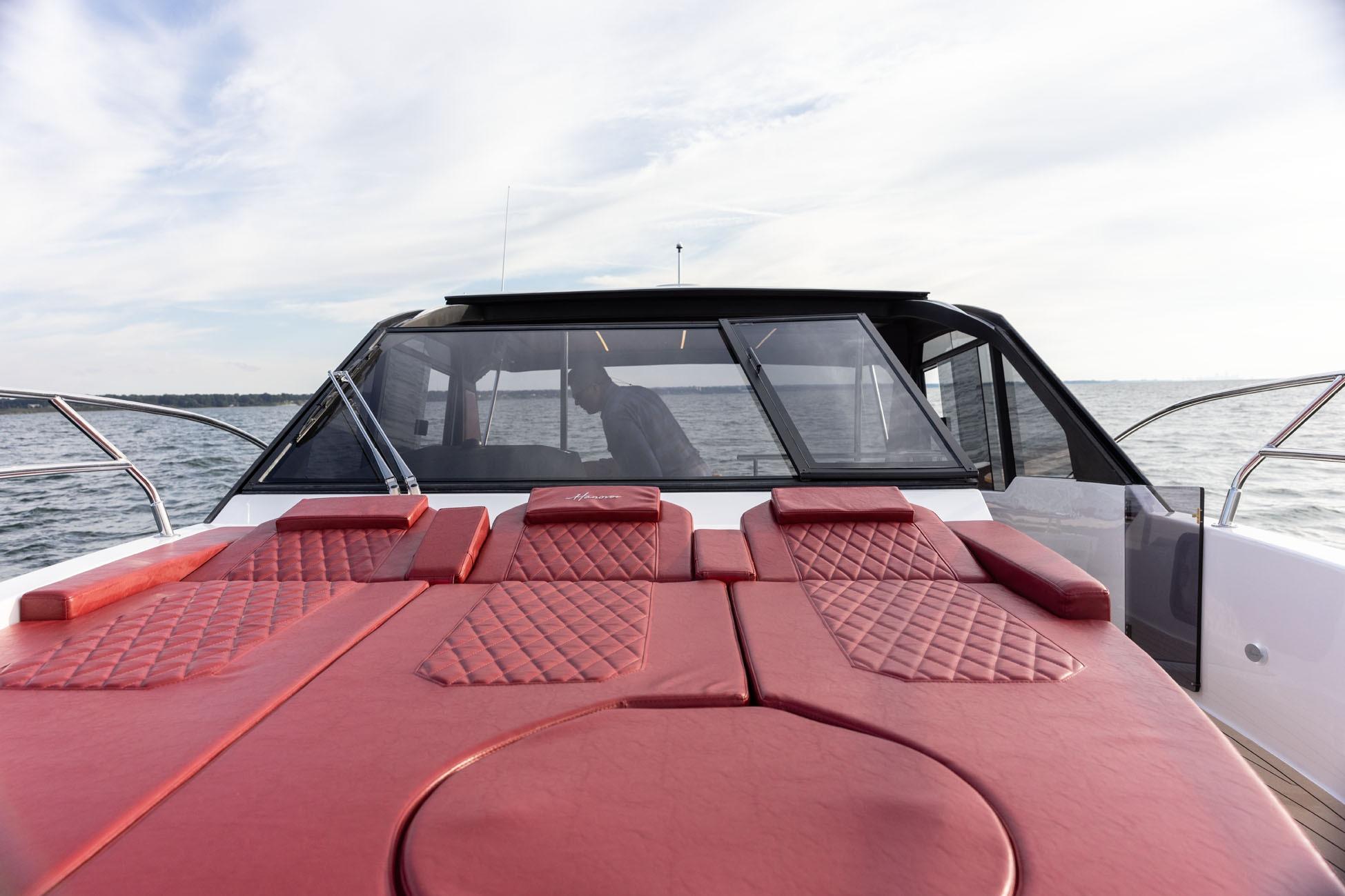 Luxury Hanover 387 yacht with red leather seating, cruising on open water, 2026 model.