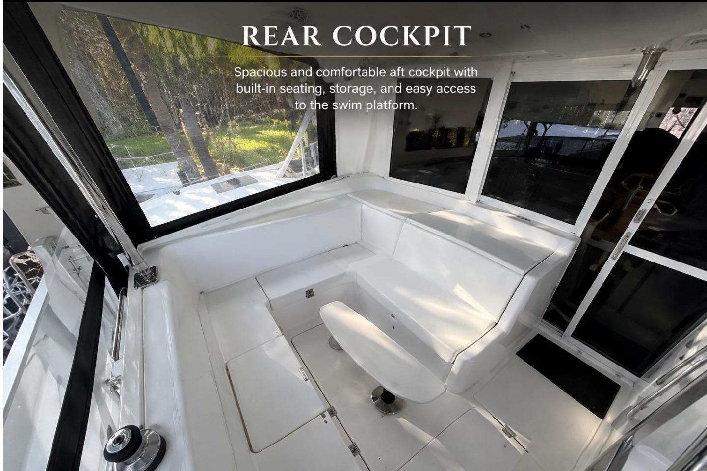 Spacious rear cockpit of 2010 Lagoon 421 catamaran, featuring comfortable seating and panoramic views.