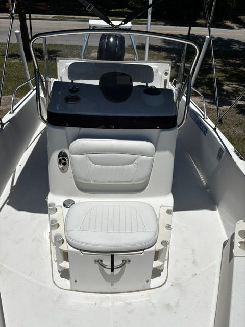 The image shows the cockpit of a 2008 Boston Whaler 200 Dauntless with white seating.