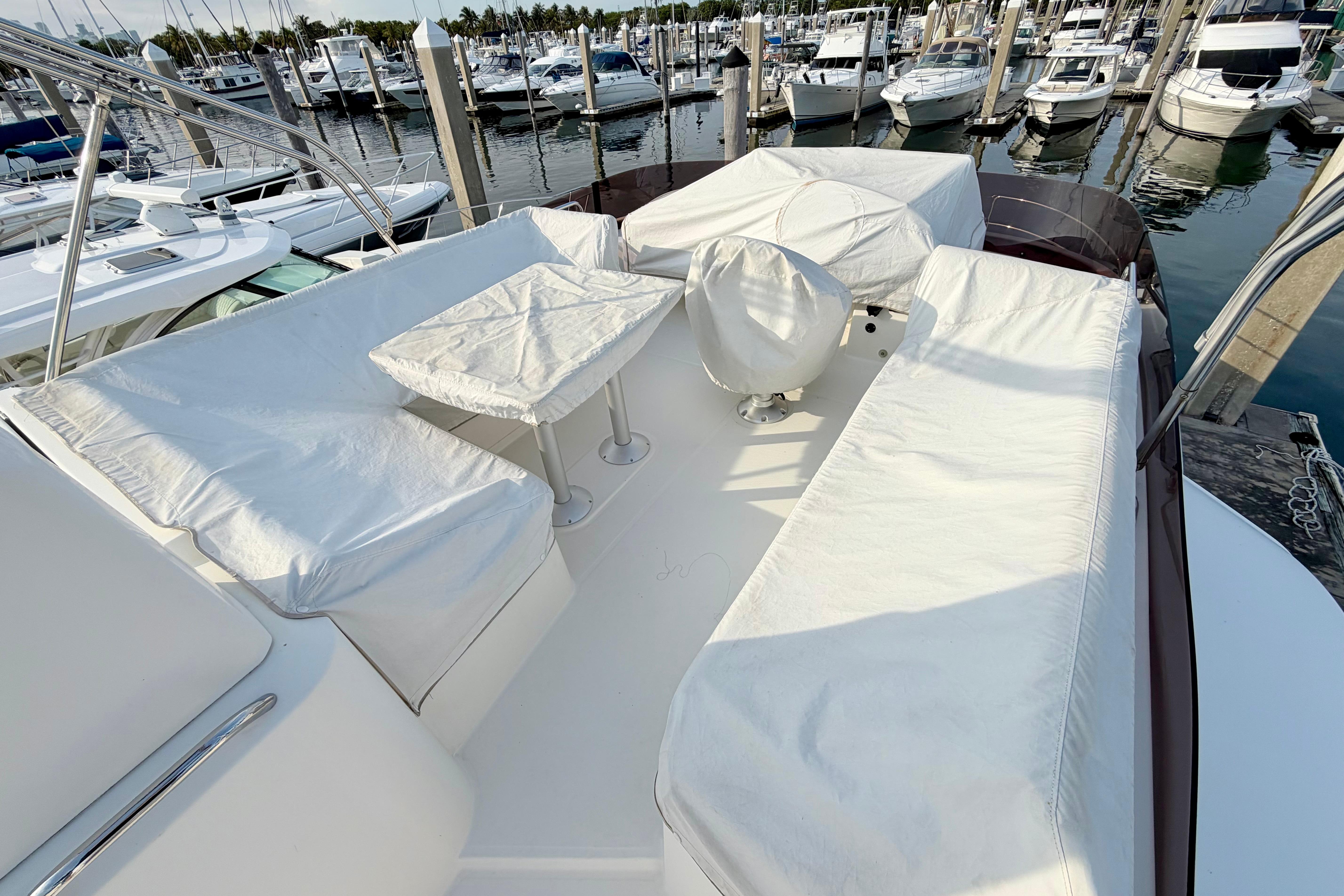 Flybridge of 2021 Beneteau Swift Trawler 41 Fly, featuring covered seating and table.