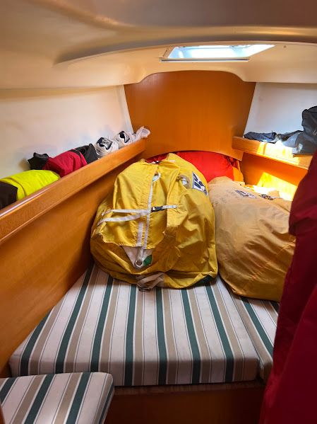 Interior of a 2000 Beneteau First 40.7 yacht with sails and storage.