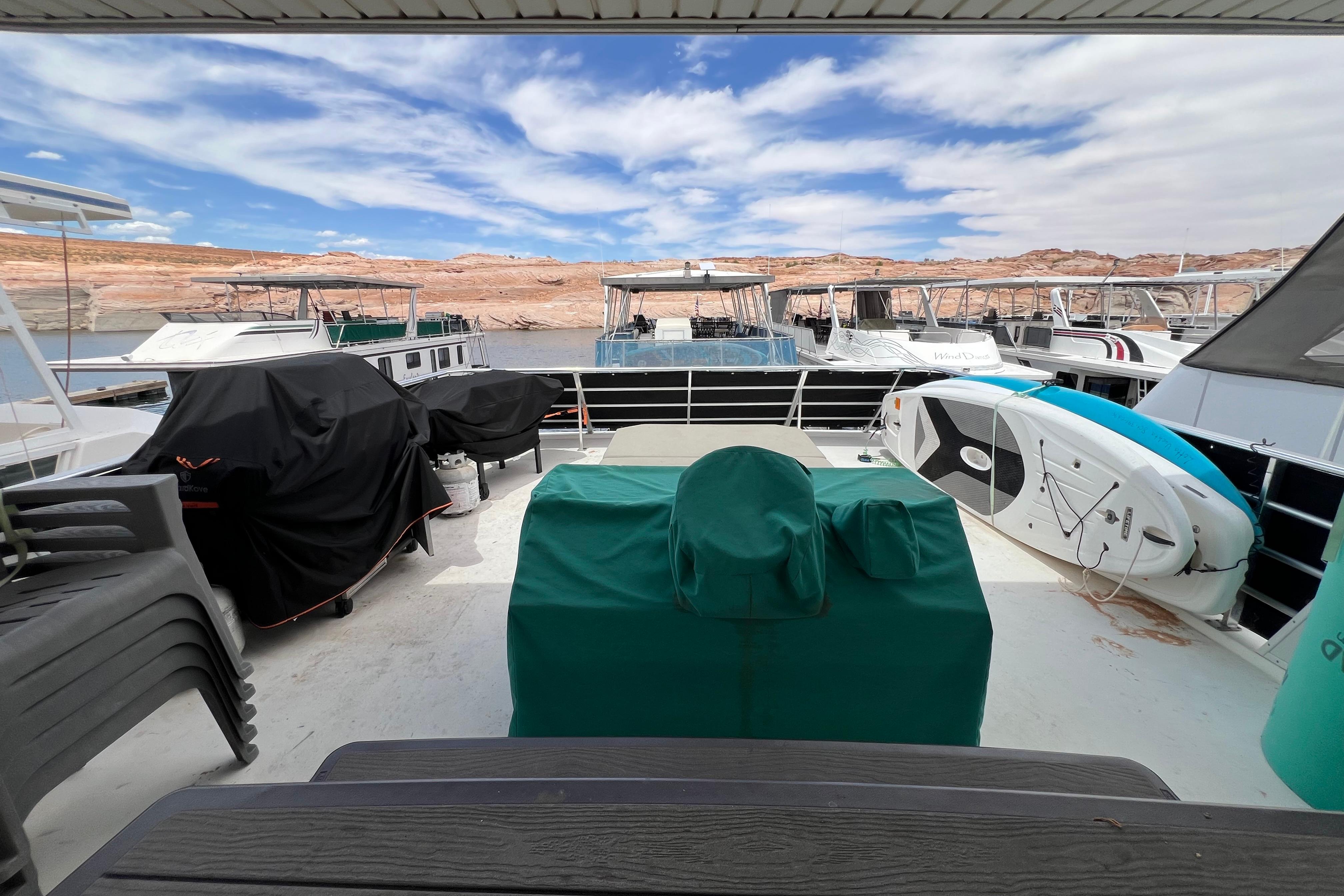 Deck view of 2013 Destination Yacht Lotta Yachta with paddleboard and covered equipment.
