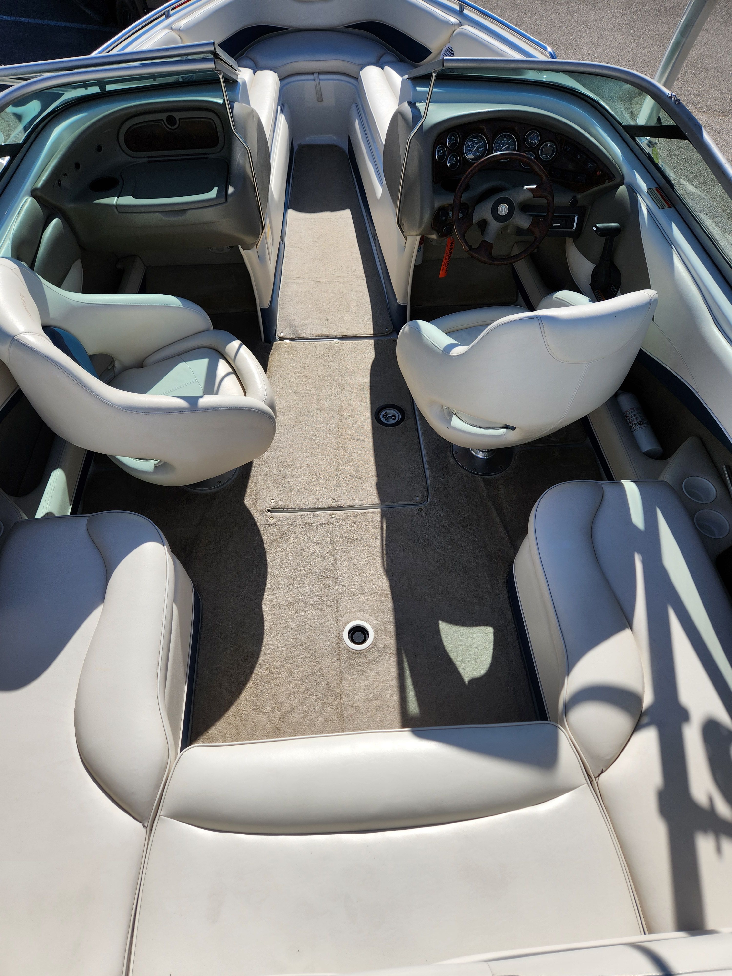 Interior of a 2003 Crownline 225 BR boat with white seating.