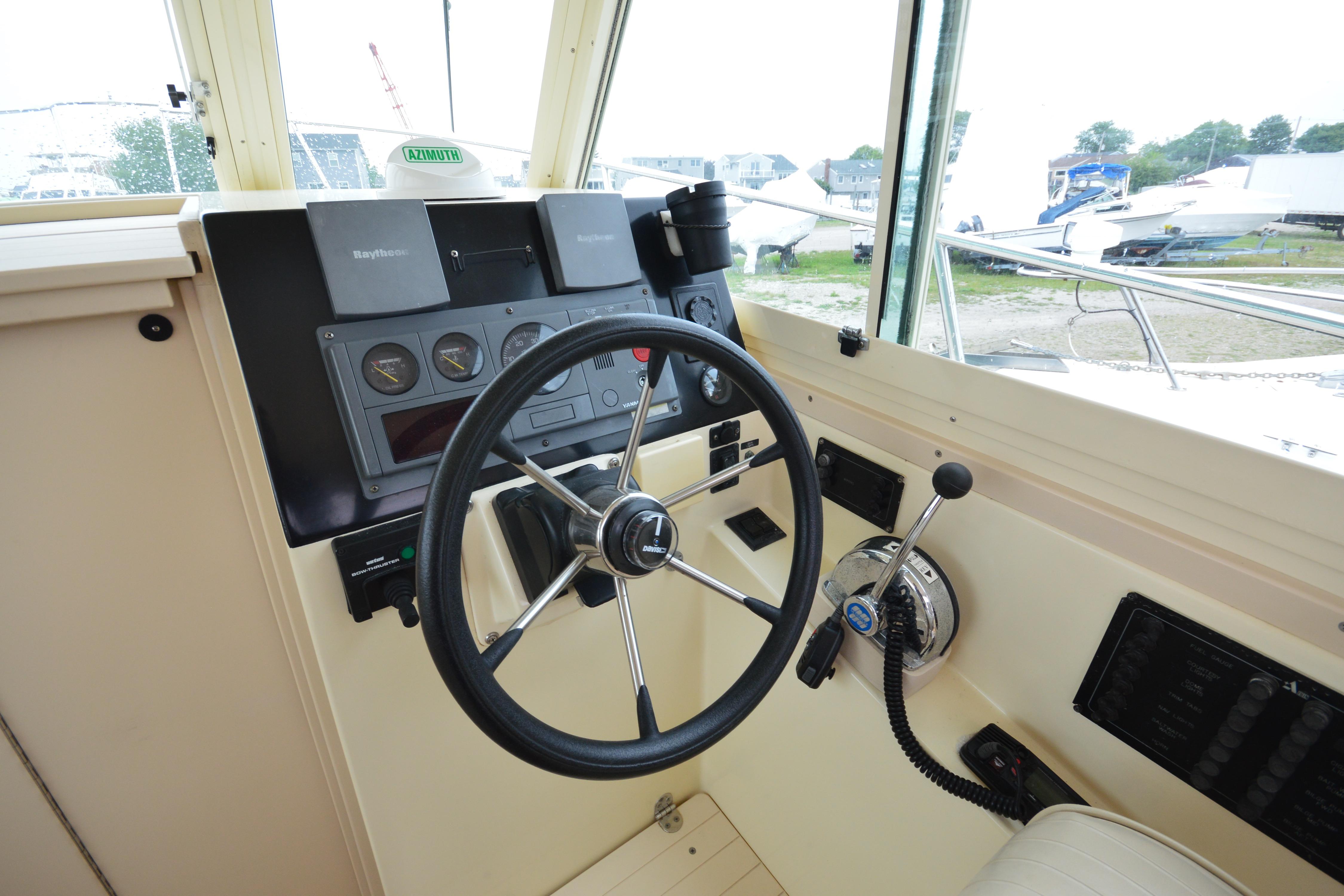 2001 Albin 28 Tournament Express helm with steering wheel and navigation controls.