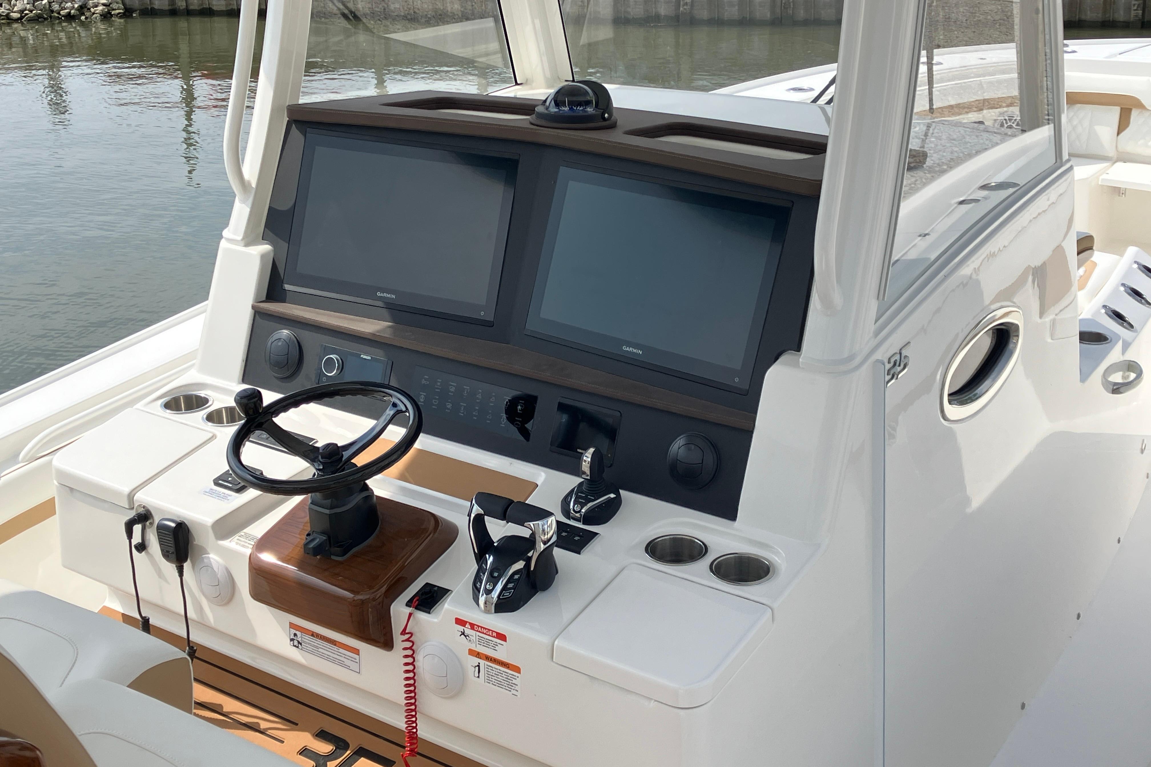 Helm of 2027 Regulator 35 boat with dual screens and steering wheel.