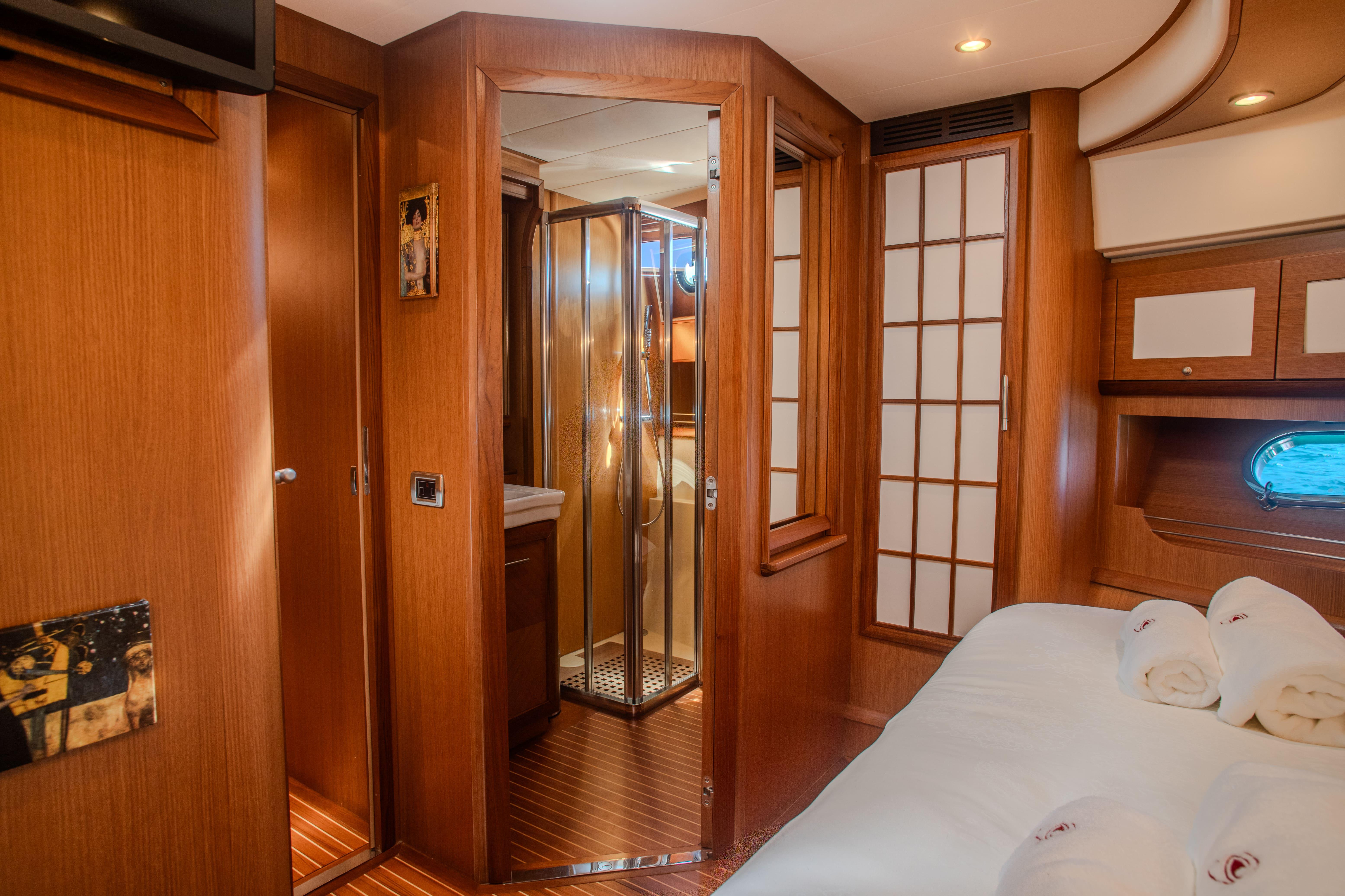 Luxurious cabin interior of 2005 Mochi Craft 74' Dolphin yacht with ensuite bathroom.