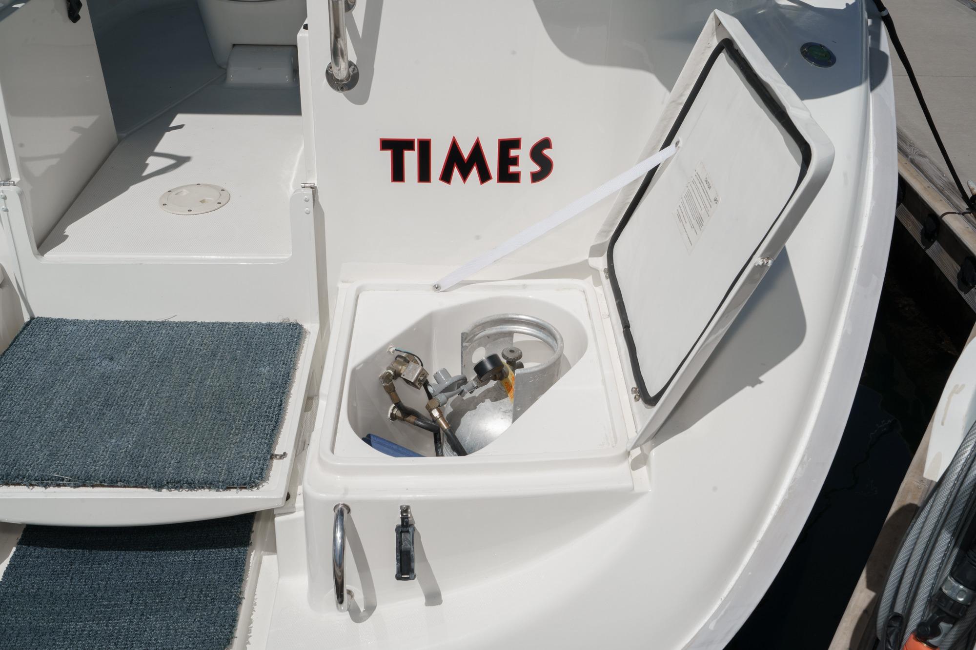 Open hatch on 1996 Hunter 376 sailboat deck with visible equipment and "TIMES" text.