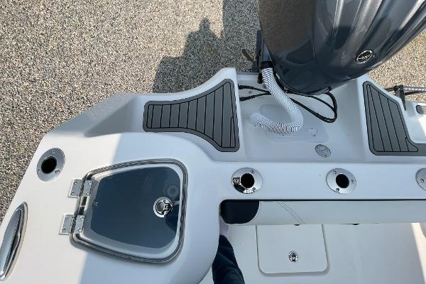 Tidewater 232 CC Adventure 2026, boat deck view with motor and rod holders.