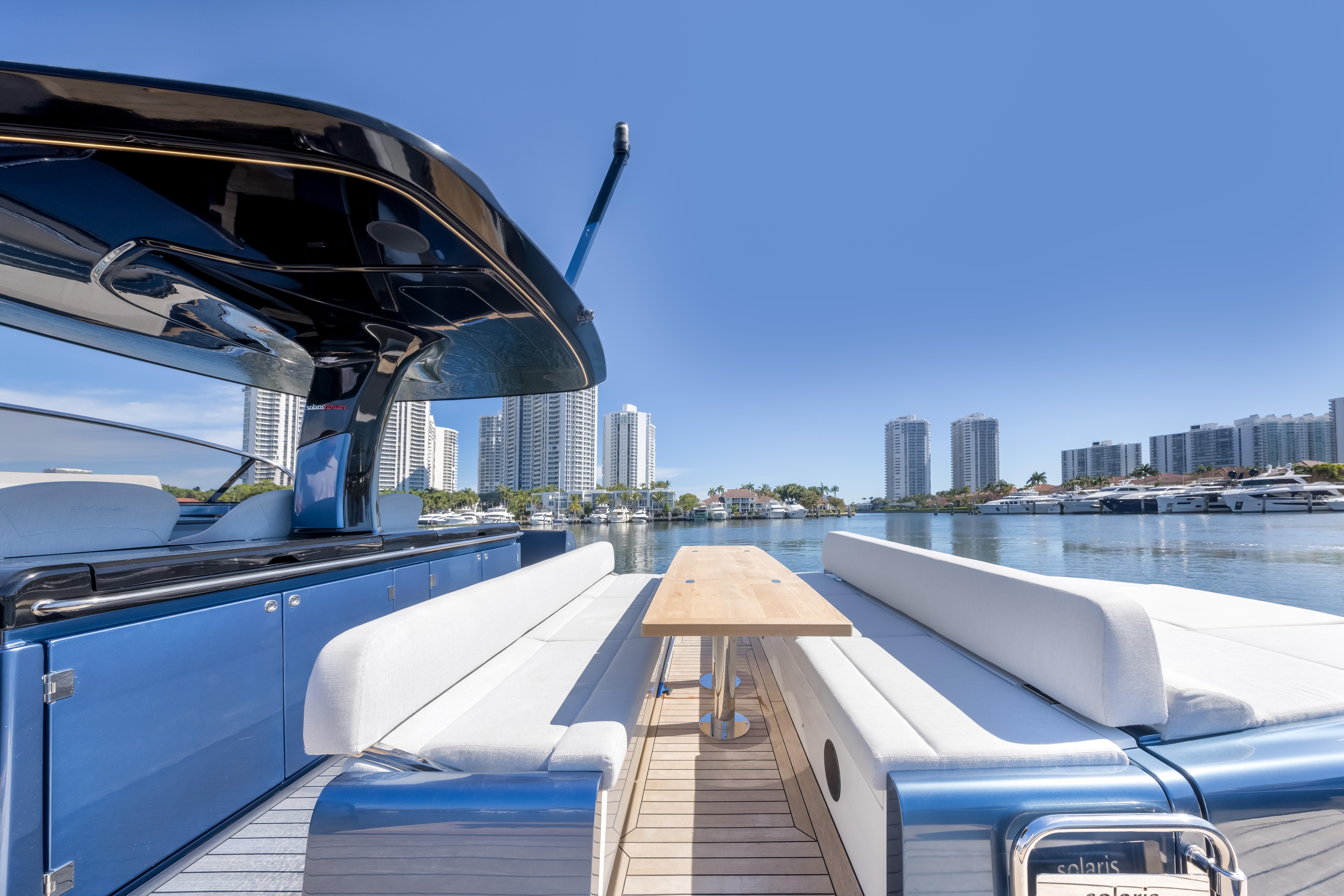2021 Solaris Power 48 OPEN yacht with sleek design, docked in a modern city marina.