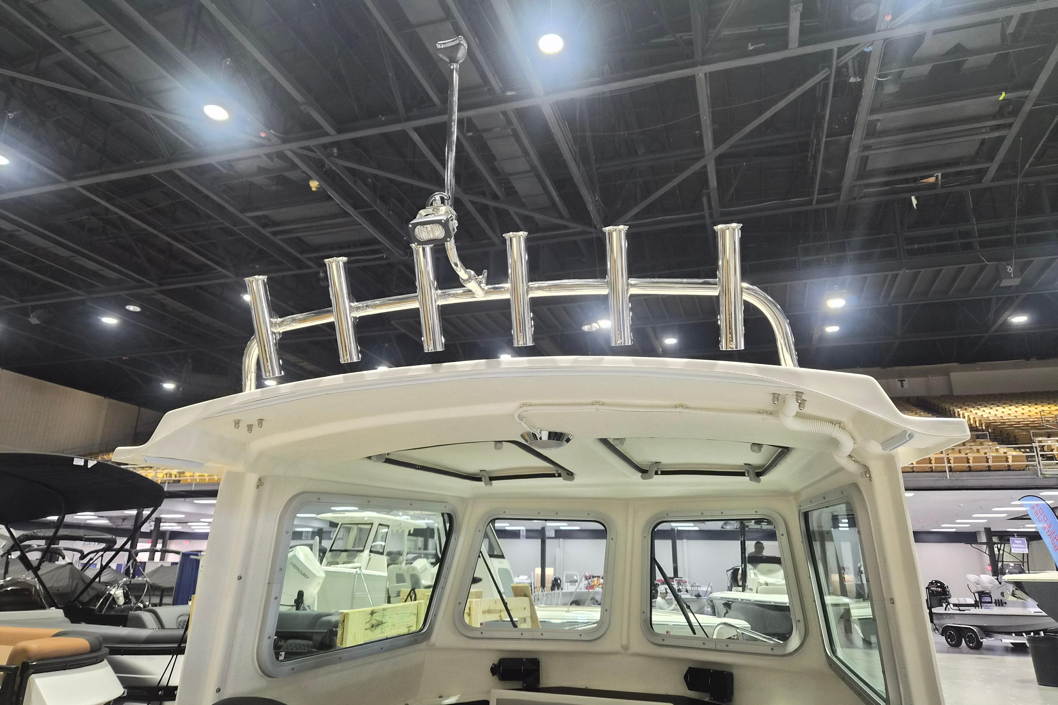 2026 Arima Sea Chaser 19 Yellowtail Edition boat interior with rod holders displayed indoors.