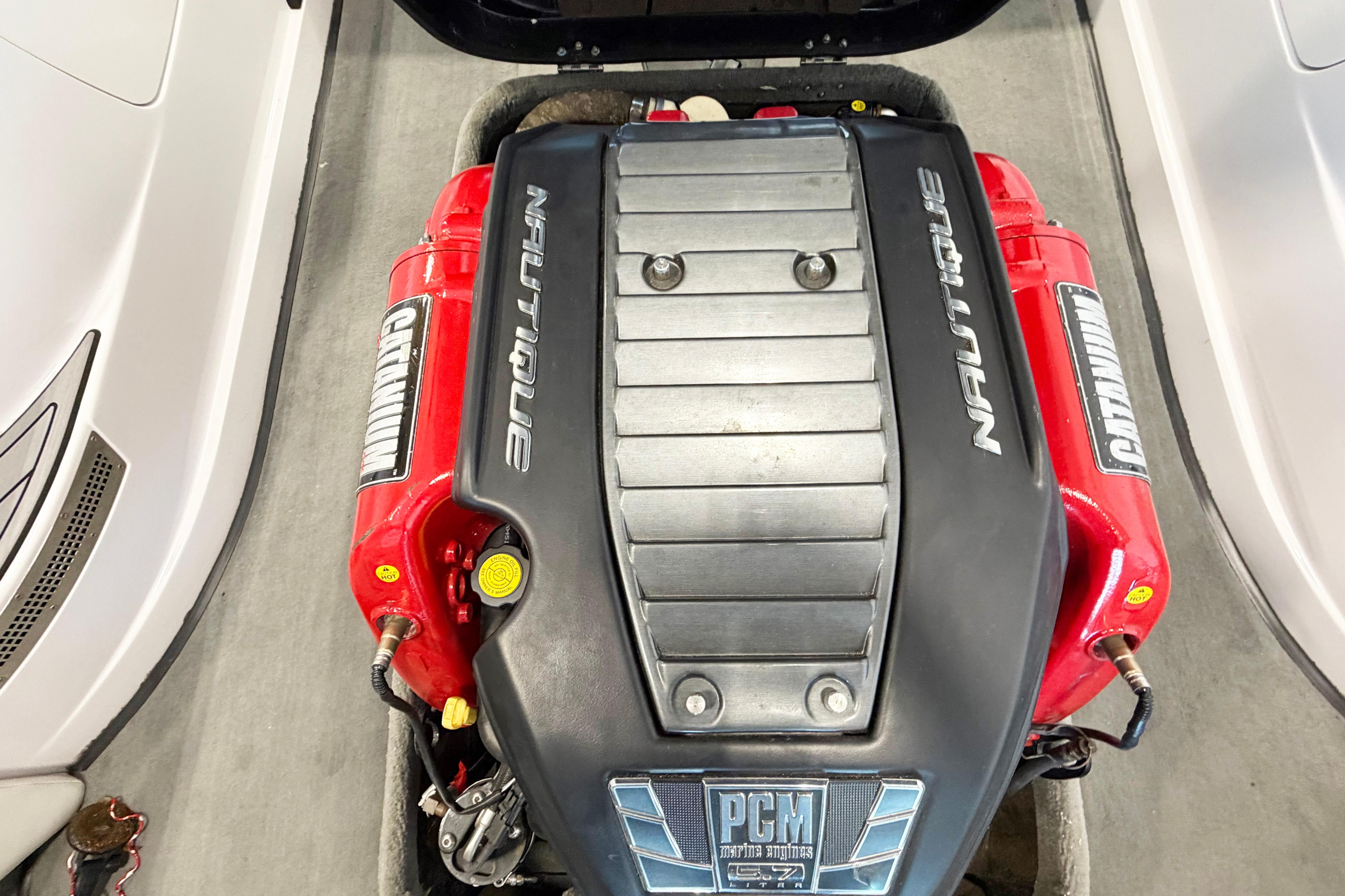 2014 Nautique Ski Nautique 200 Open Bow engine, featuring PCM components and red accents.