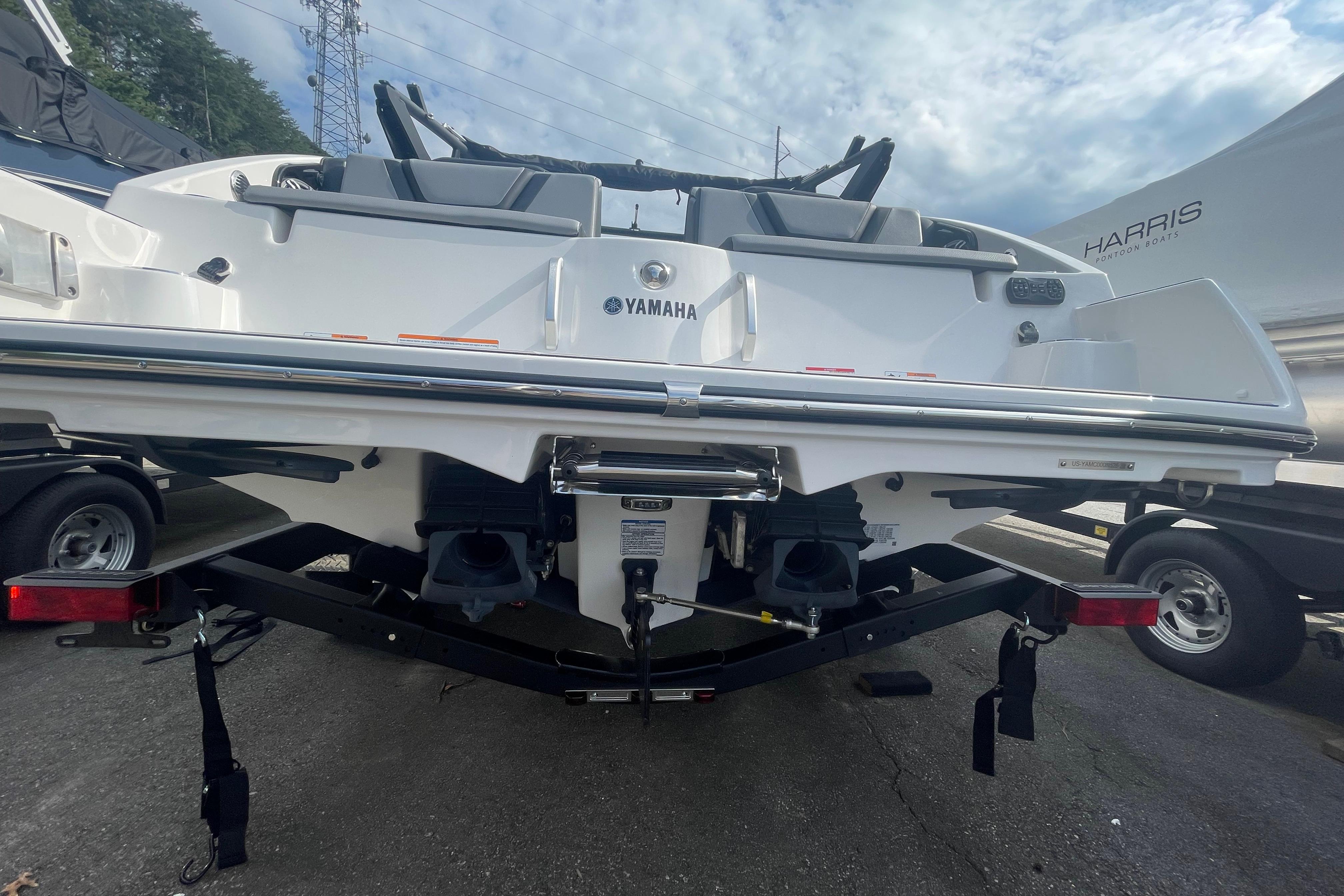 2026 Yamaha Boats 222XD on trailer, rear view, showcasing sleek design and dual engines.