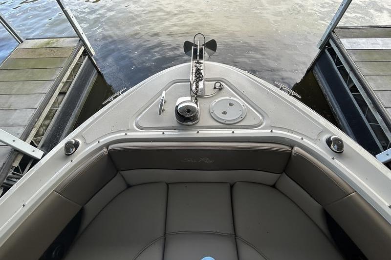 Bow view of a 2011 Sea Ray 300 SLX boat docked by the water.