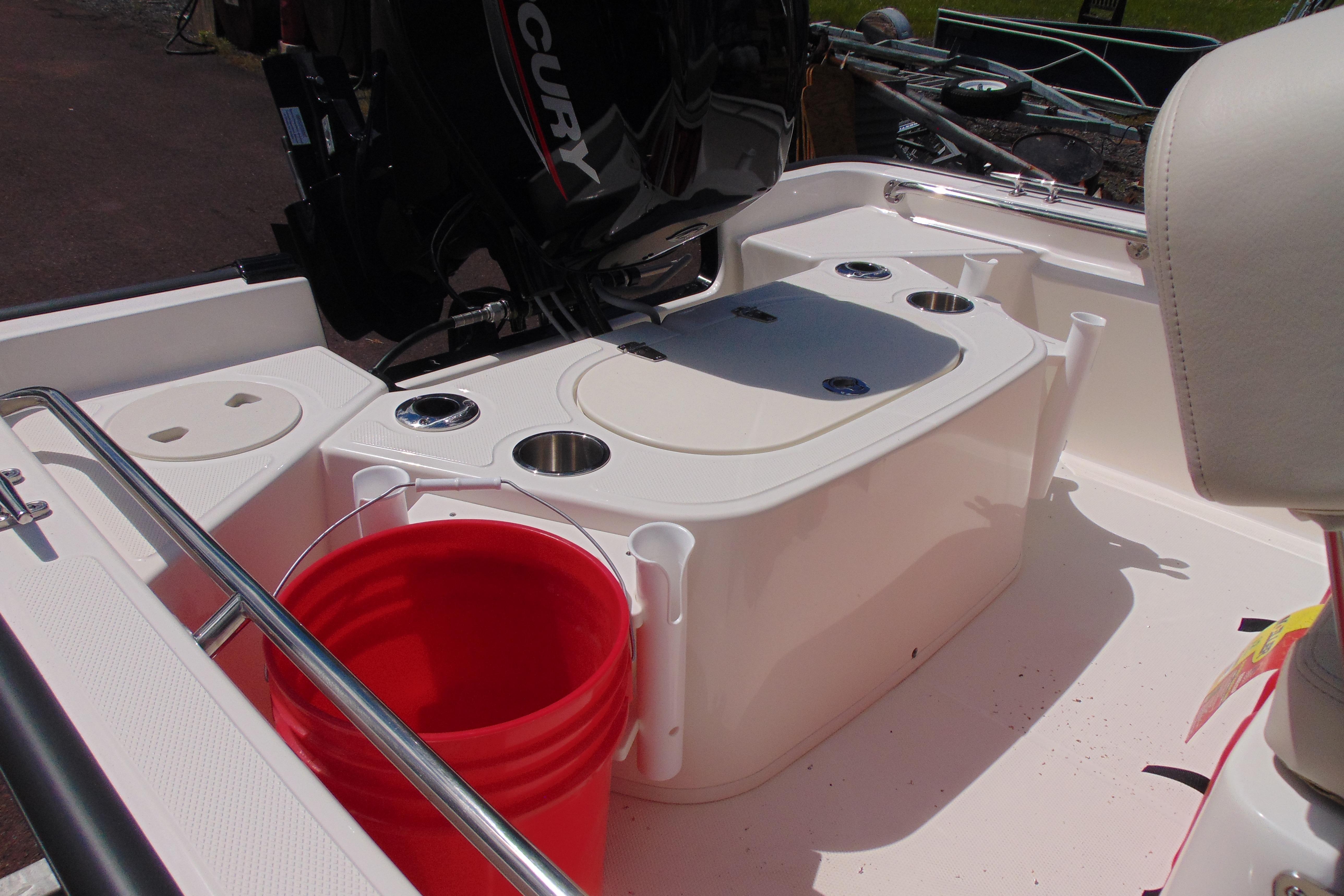 2026 Boston Whaler 150 Montauk boat interior with red bucket and engine.