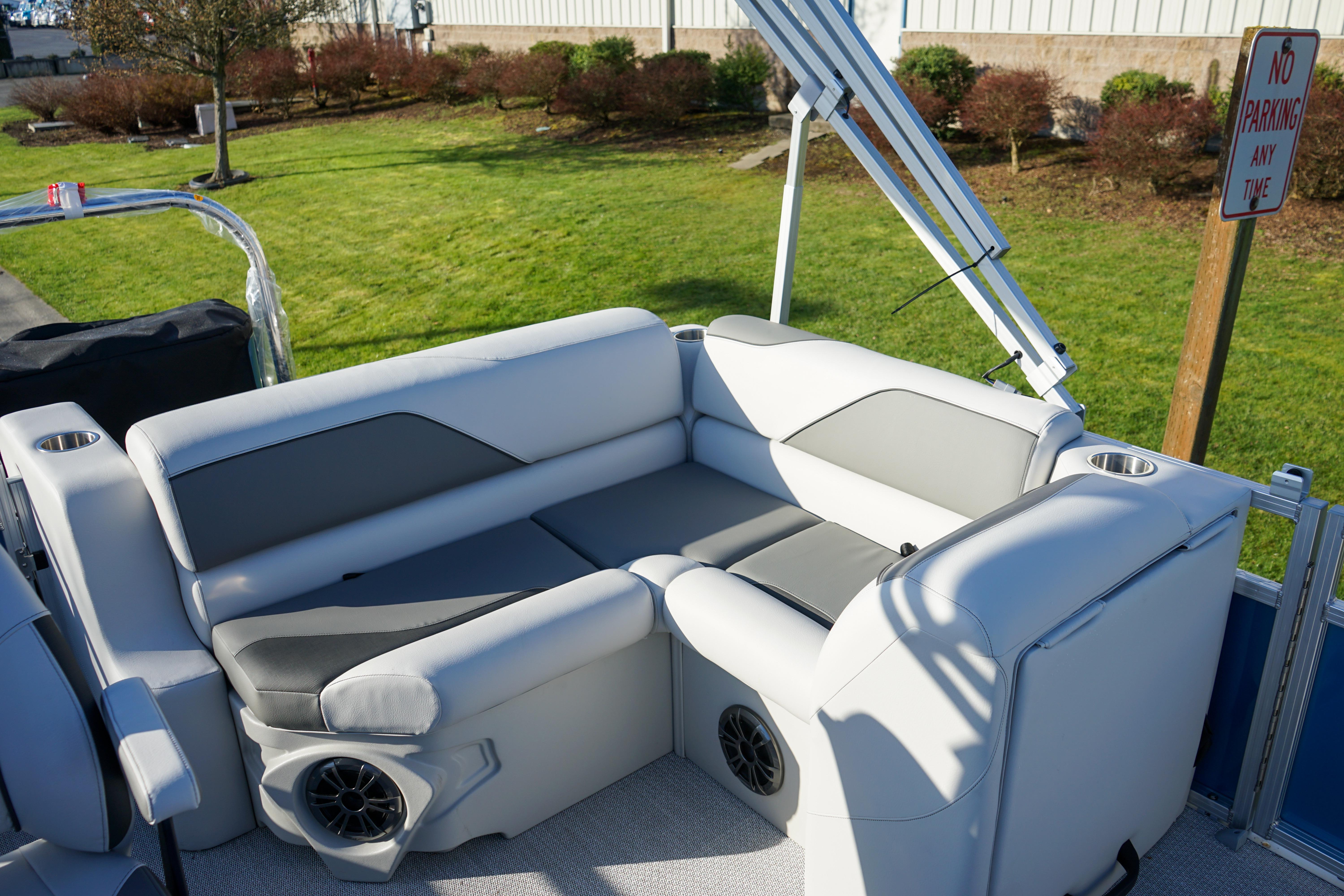 Luxurious seating on 2024 Avalon 17 Venture Cruise pontoon boat, featuring cup holders and speakers.