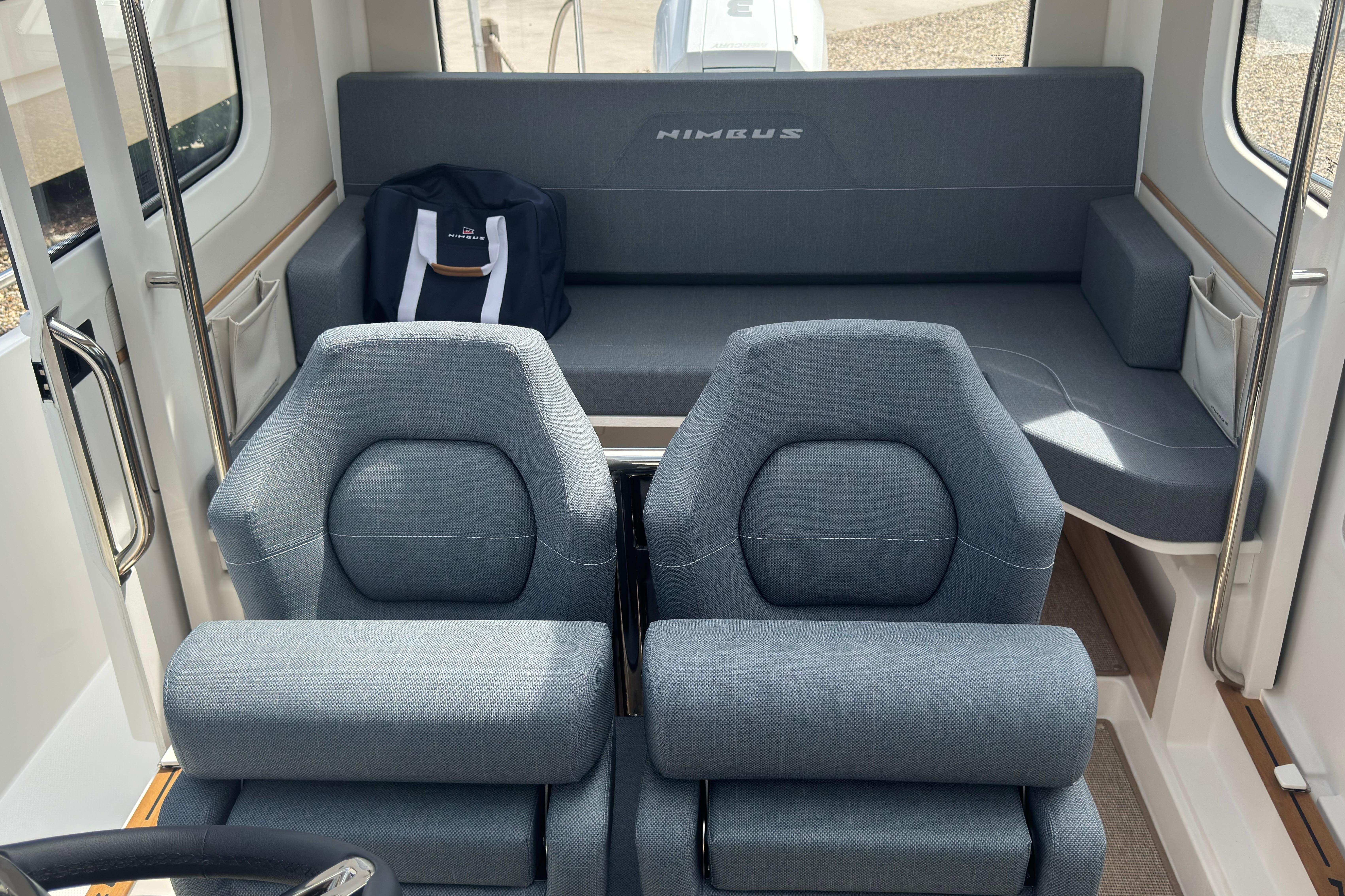 Interior of a Nimbus Commuter 9 with two cushioned seats and a rear bench.