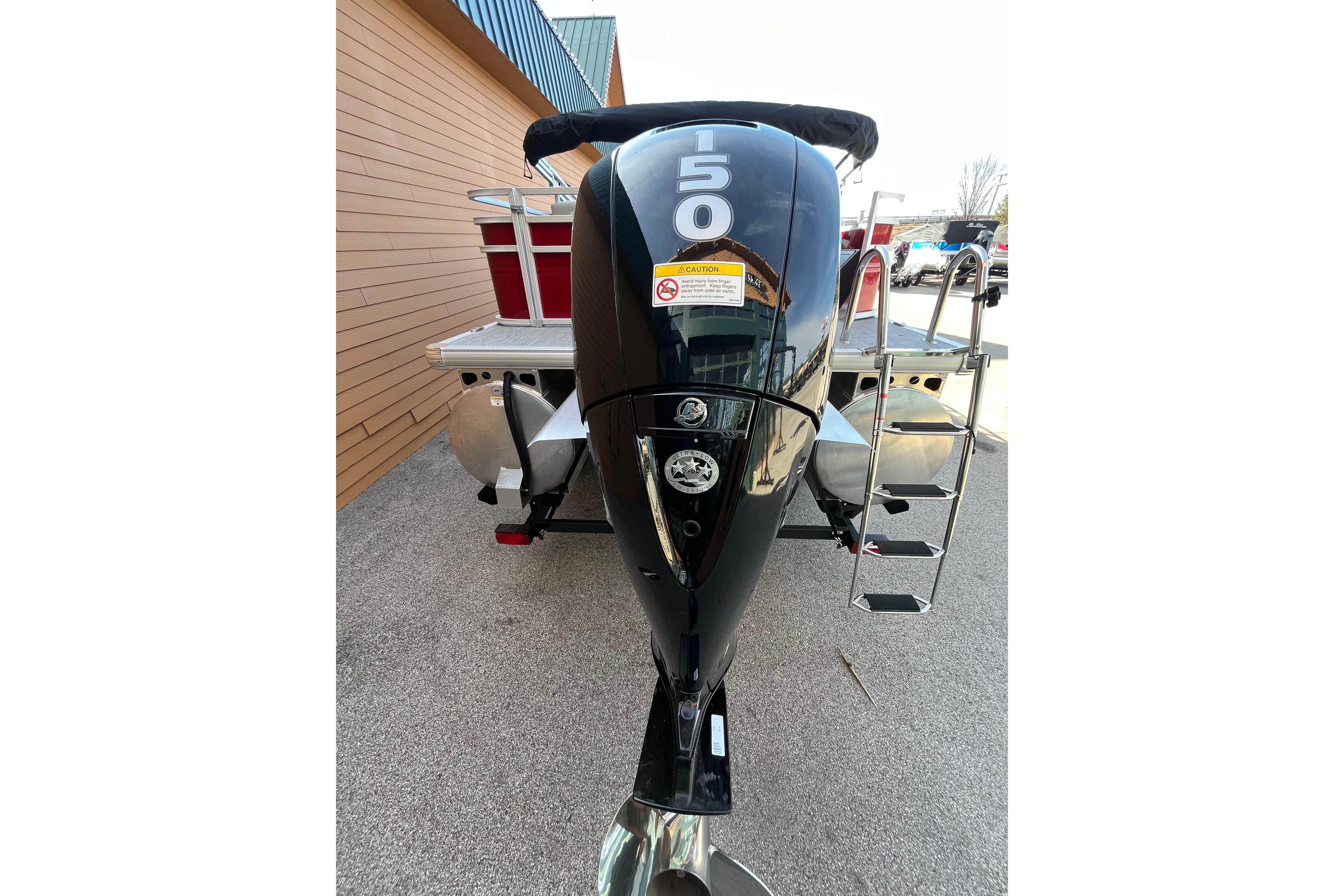 2026 Sun Tracker Fishin' Barge 22 XP3 with powerful 150 HP engine, rear view.