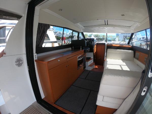 Interior of 2017 Jeanneau NC 11 boat with modern seating and kitchen area.