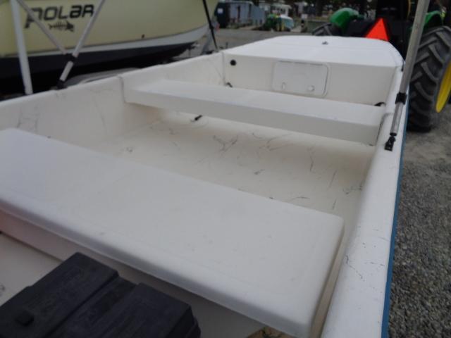 White Sundance K14T boat interior, 2010 model, with bench seating and storage compartments.