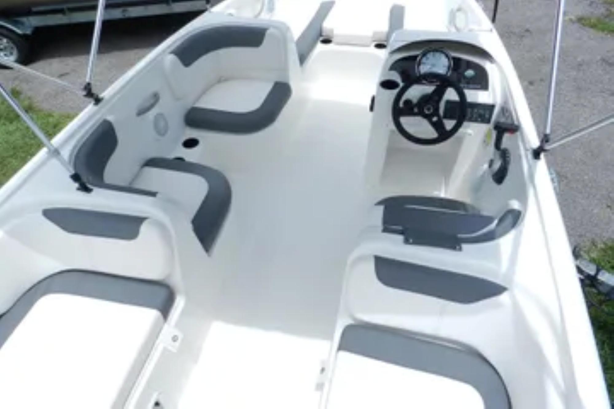 2026 Bayliner Element E18 boat interior with seating and steering console.