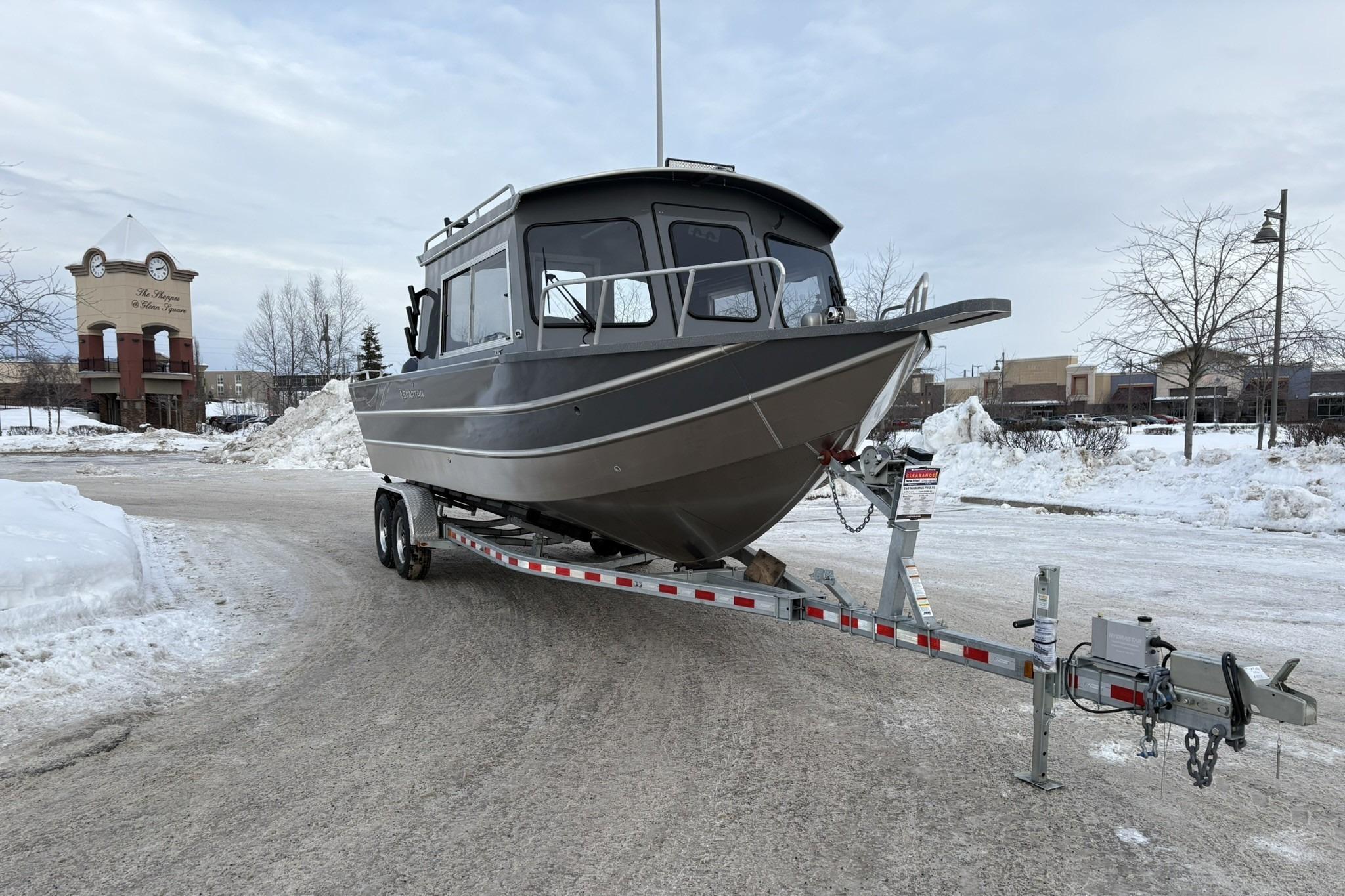 2024 Spartan 26 Maximus Pro XL boat on trailer in snowy parking lot.