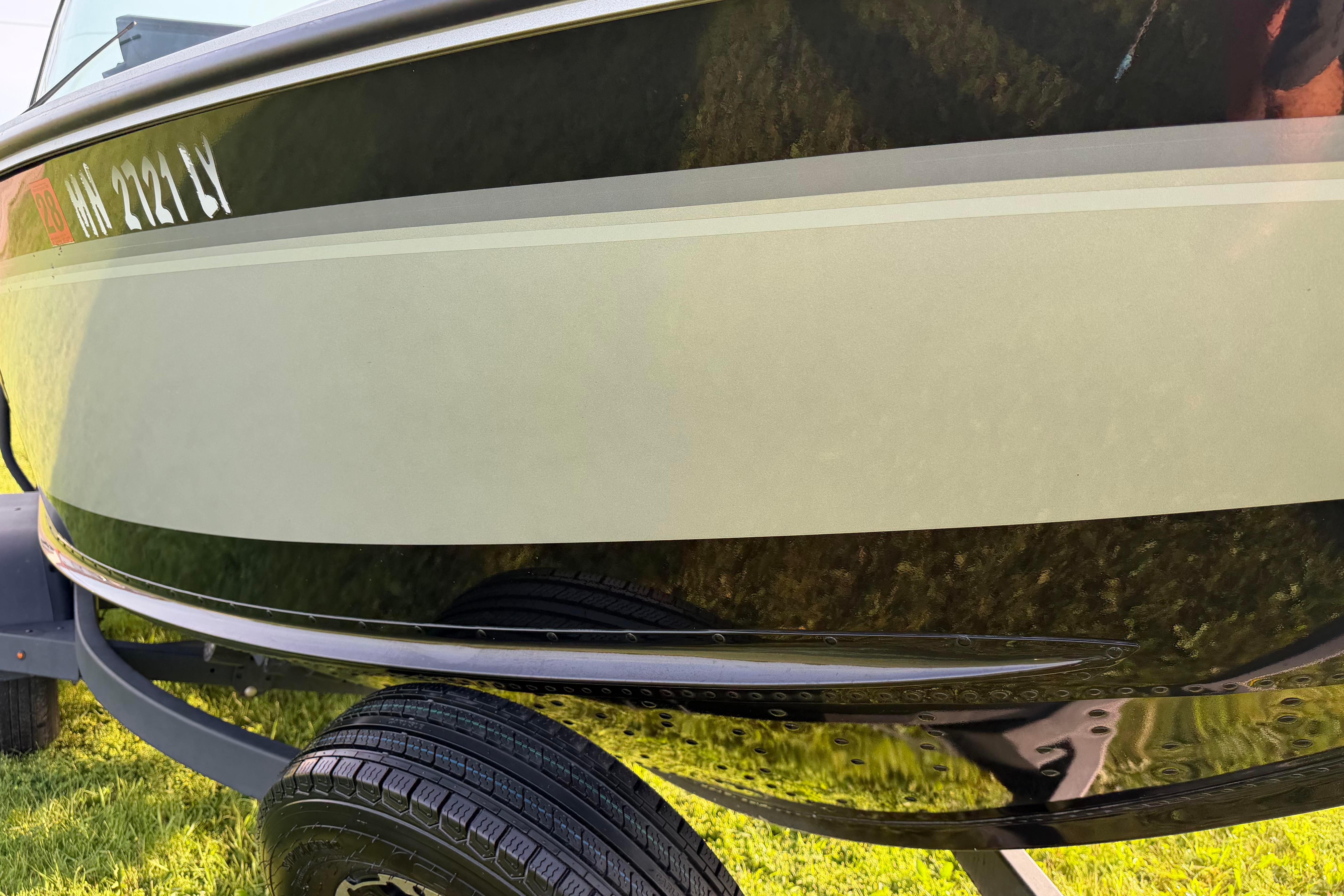 2019 Alumacraft Trophy 205 boat on trailer, close-up view of hull and registration.