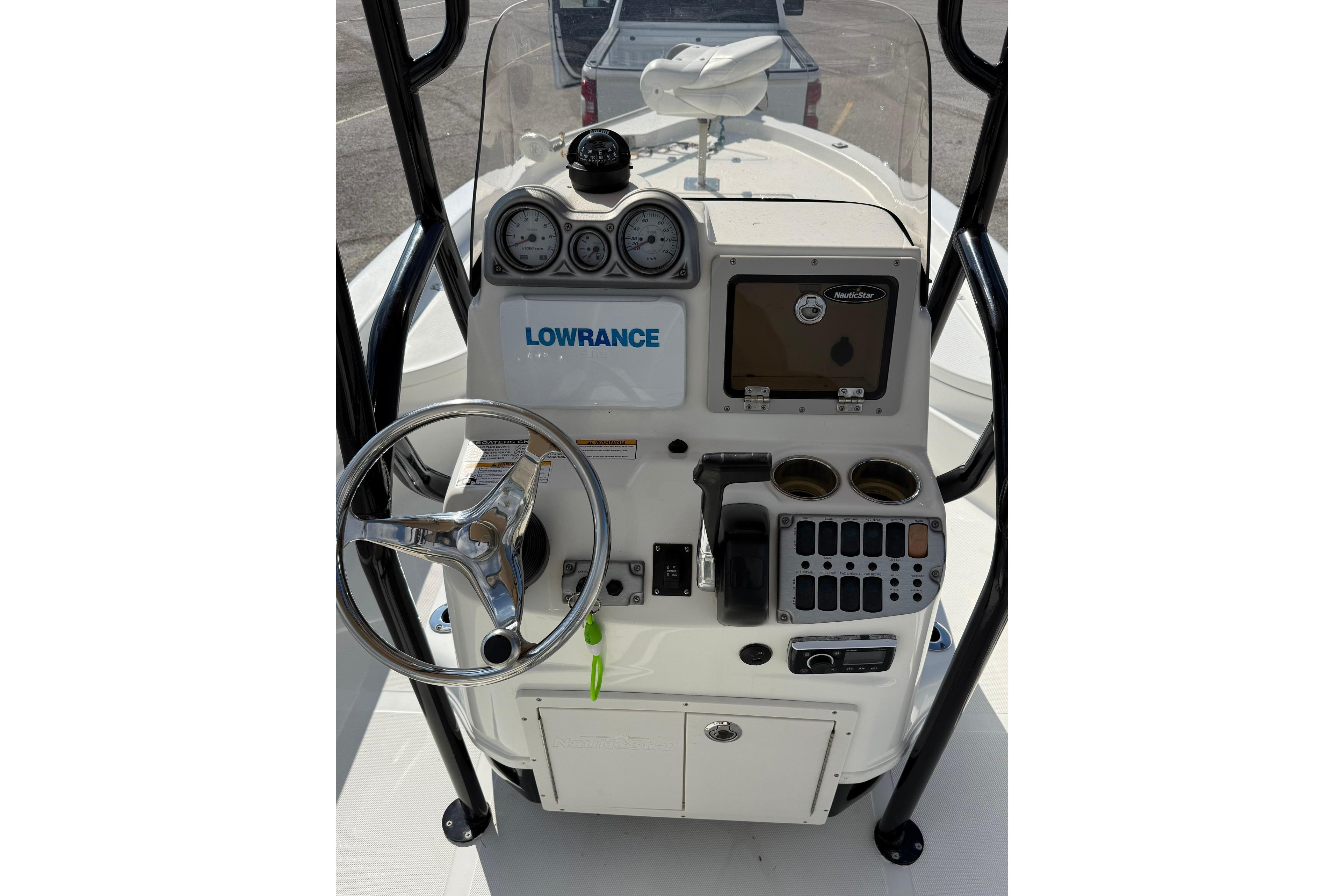 2015 NauticStar 224 XTS boat console with steering wheel and Lowrance electronics.