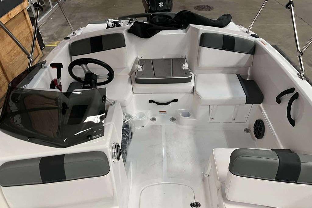 2026 Tahoe T16 boat interior with seating, steering wheel, and storage compartments.