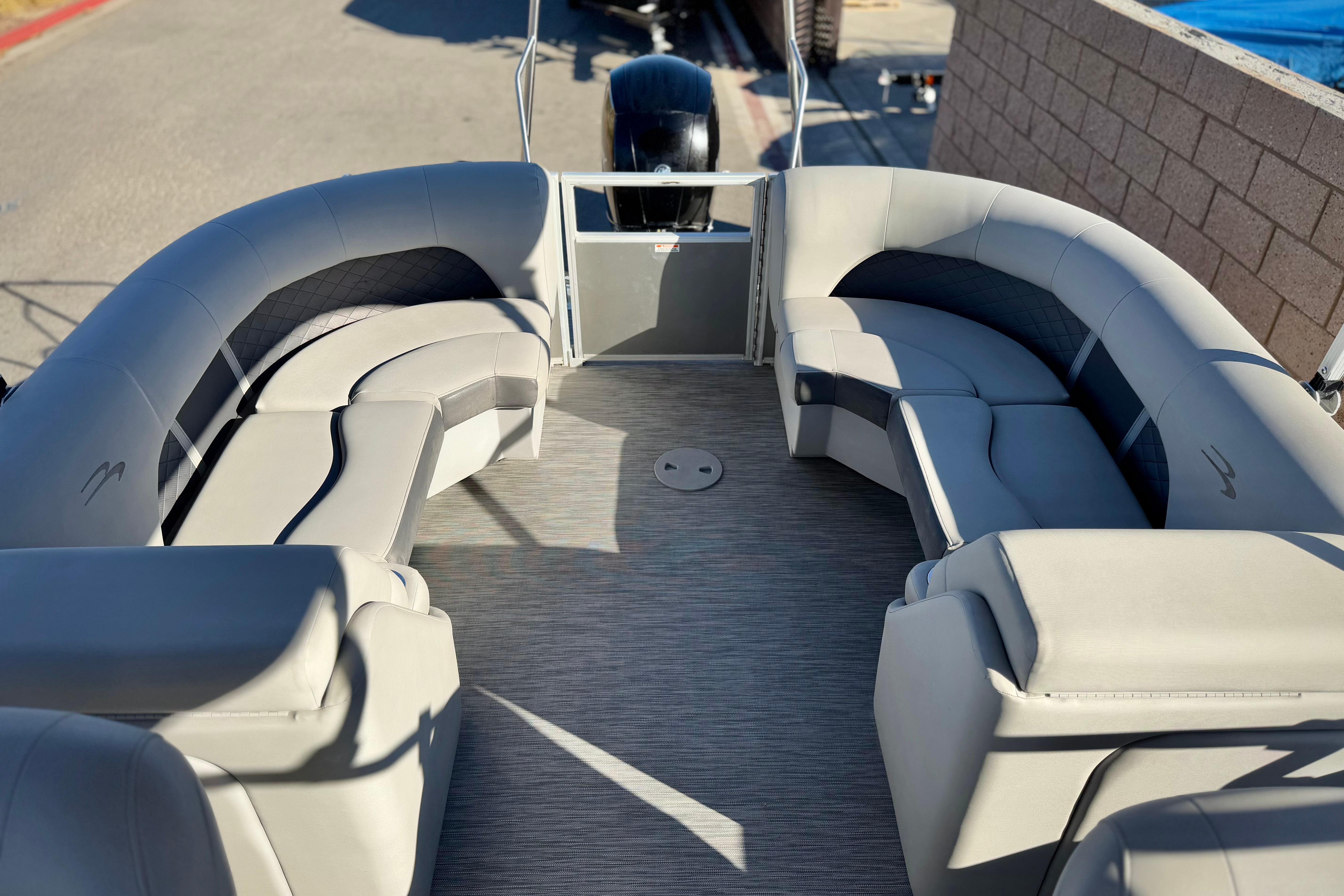 2021 Bennington 23LSR pontoon boat interior with plush gray seating and spacious layout.