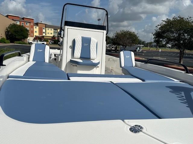 2025 Ranger 2360 Bay boat with blue and white seating, parked outdoors under a cloudy sky.