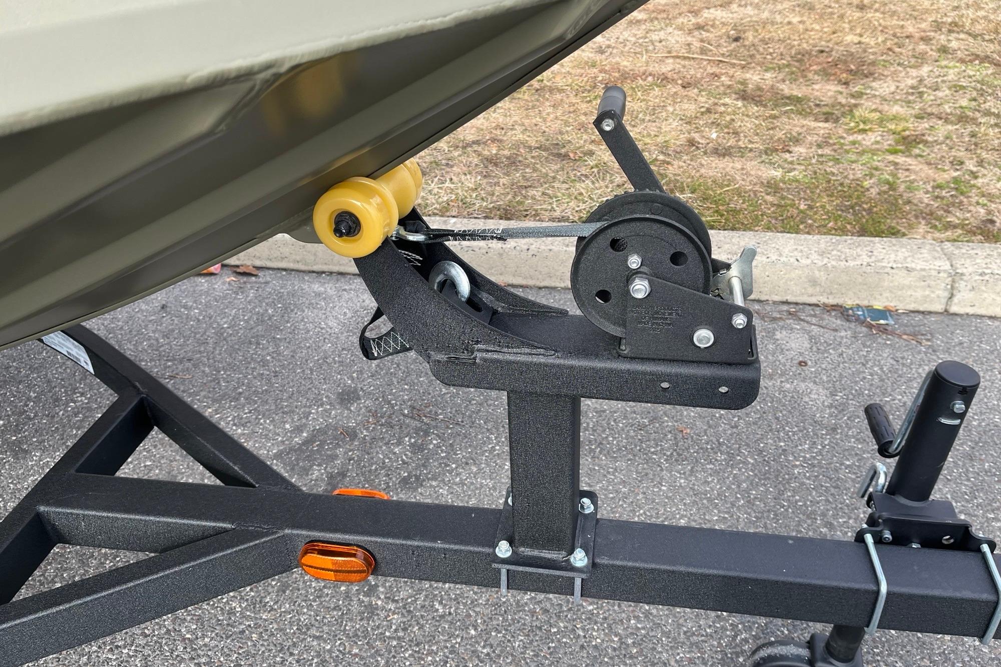 2026 Tracker Grizzly 1754 Utility boat trailer winch on asphalt surface.