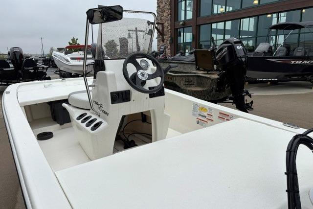 2025 Mako Pro Skiff 13 CC boat with steering console, displayed outdoors.