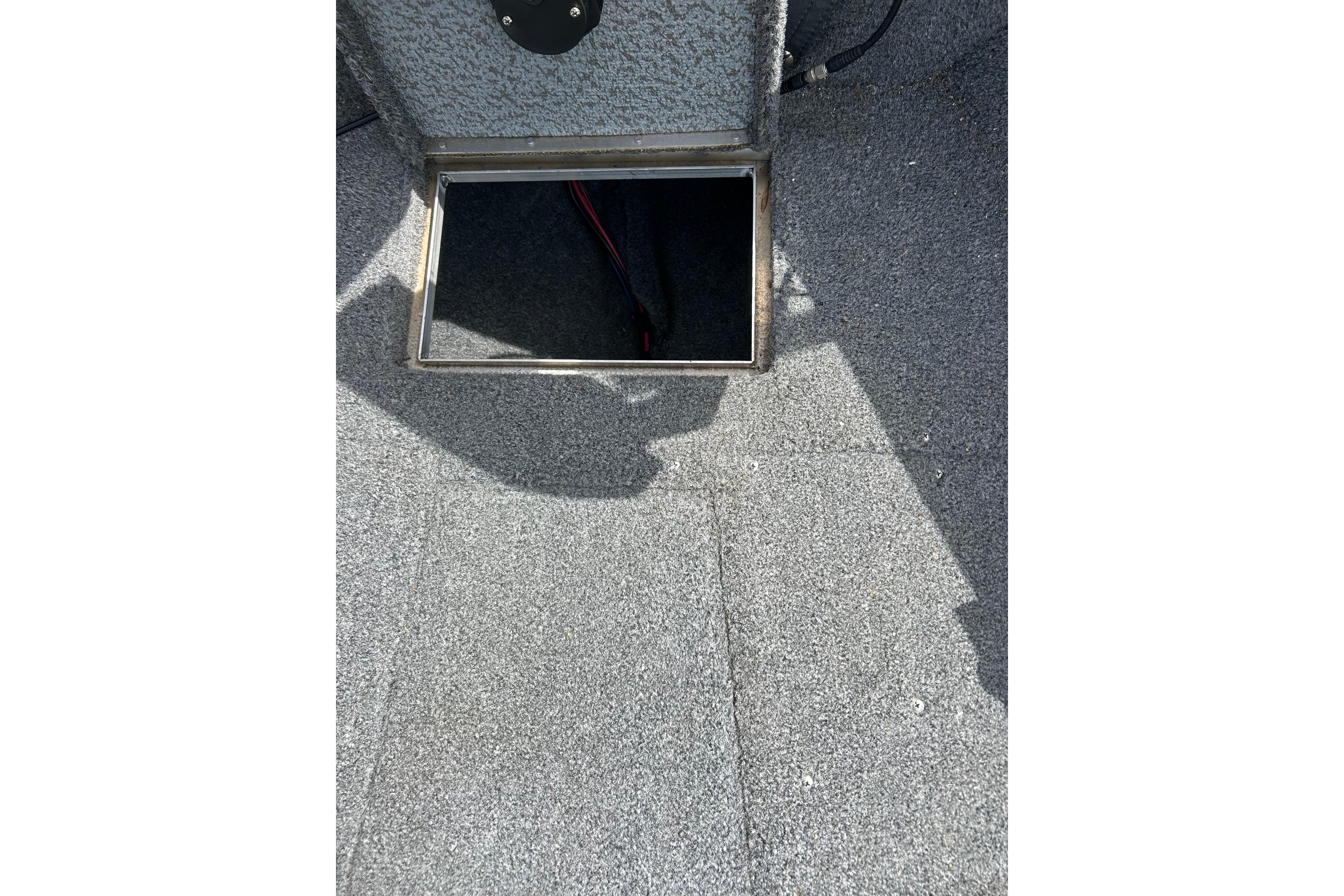 Open storage compartment on 2008 Lund 1850 Fisherman boat deck.